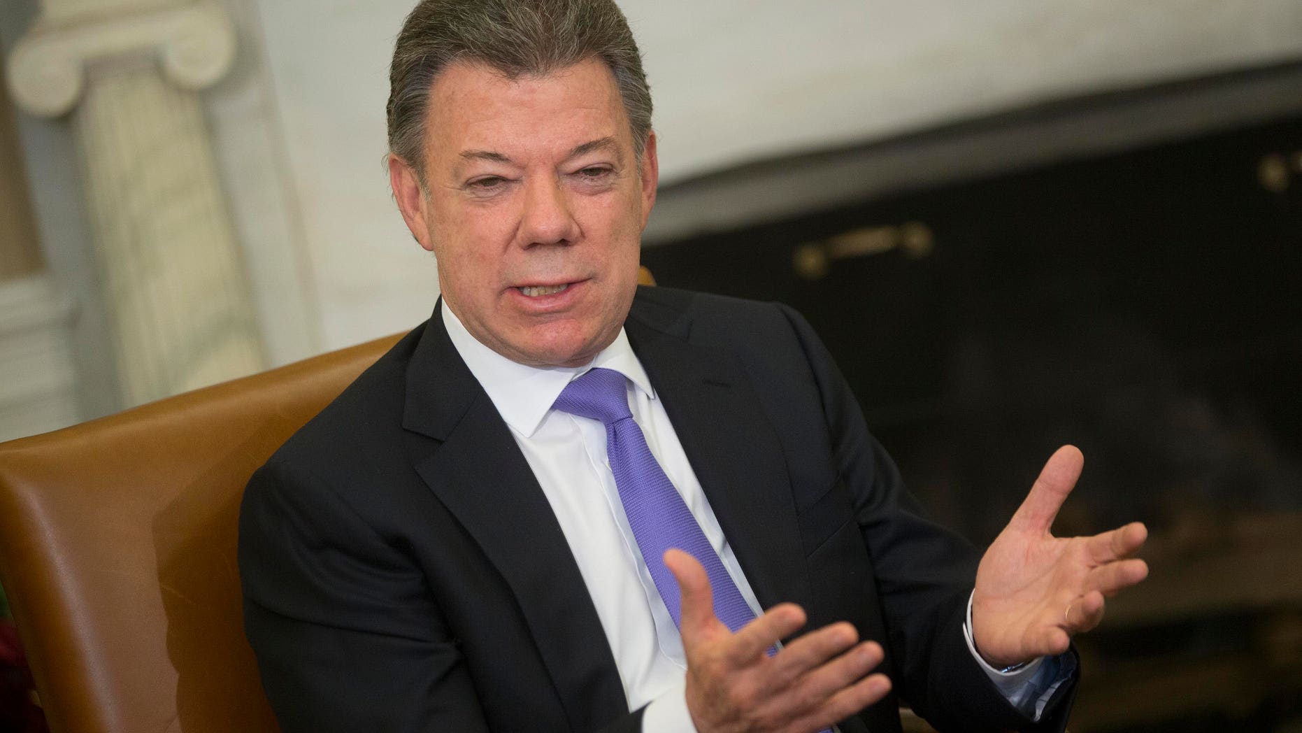 WASHINGTON, DC - DECEMBER 3: Colombian President Juan Manuel Santos speaks during a meeting with U.S. President Barack Obama in the Oval Office of the White House December 3, 2013 in Washington, DC. Obama and Santos commented on last year's free trade accord among other subjects. (Photo by Andrew Harrer-Pool/Getty Images)