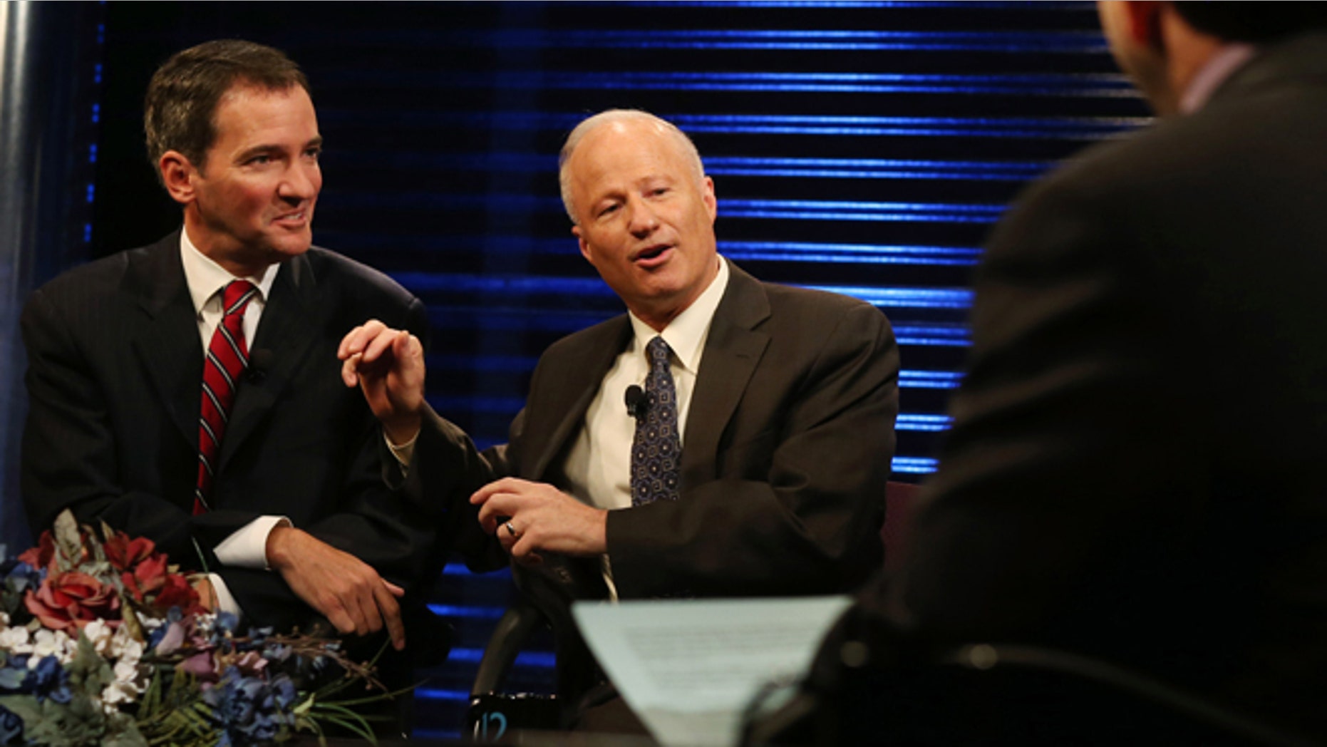 Andrew Romanoff, left, gently pushed by Republican incumbent Mike Coffman, who won his race in a diverse district. The RNC is holding Coffman up as a model for how to attract Latino voters. (AP Photo/David Zalubowski)