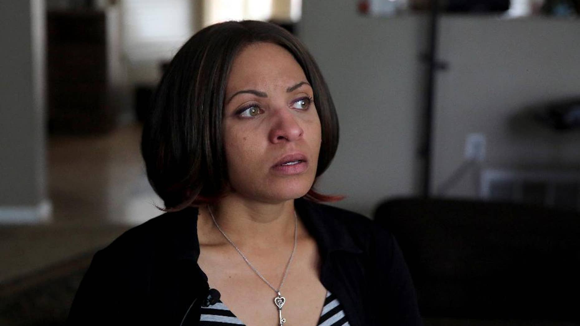 In this May 7, 2014 photo, Jasmine Lima-Marin talks during an interview with The Associated Press about her incarcerated husband Rene Lima Marin, at their home in Aurora, Colo. Rene Lima-Marin was sentenced in 2000 for a conviction in a robbery, kidnapping and burglary after robbing two Aurora video stores when Marin was 18. Marin was to stay in prison the rest of his life and serve 98 years. He was released after just 8 years due to a clerical error, living a crime-free life for six years before being sent back after authorities discovered their mistake. (AP Photo/Brennan Linsley)