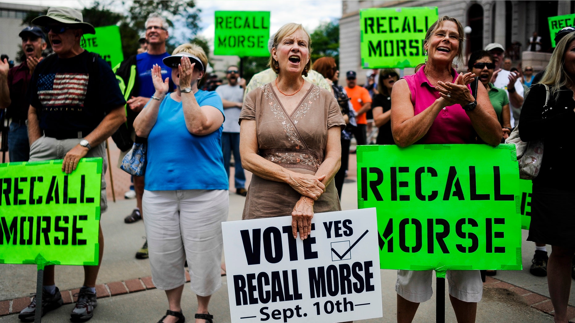 Janice Taylor, center, and other supporters of the recall election to oust Senate President John Morse rally outside the Pioneer Museum in Colorado Springs, Colo. Wednesday, Sept. 4, 2013.