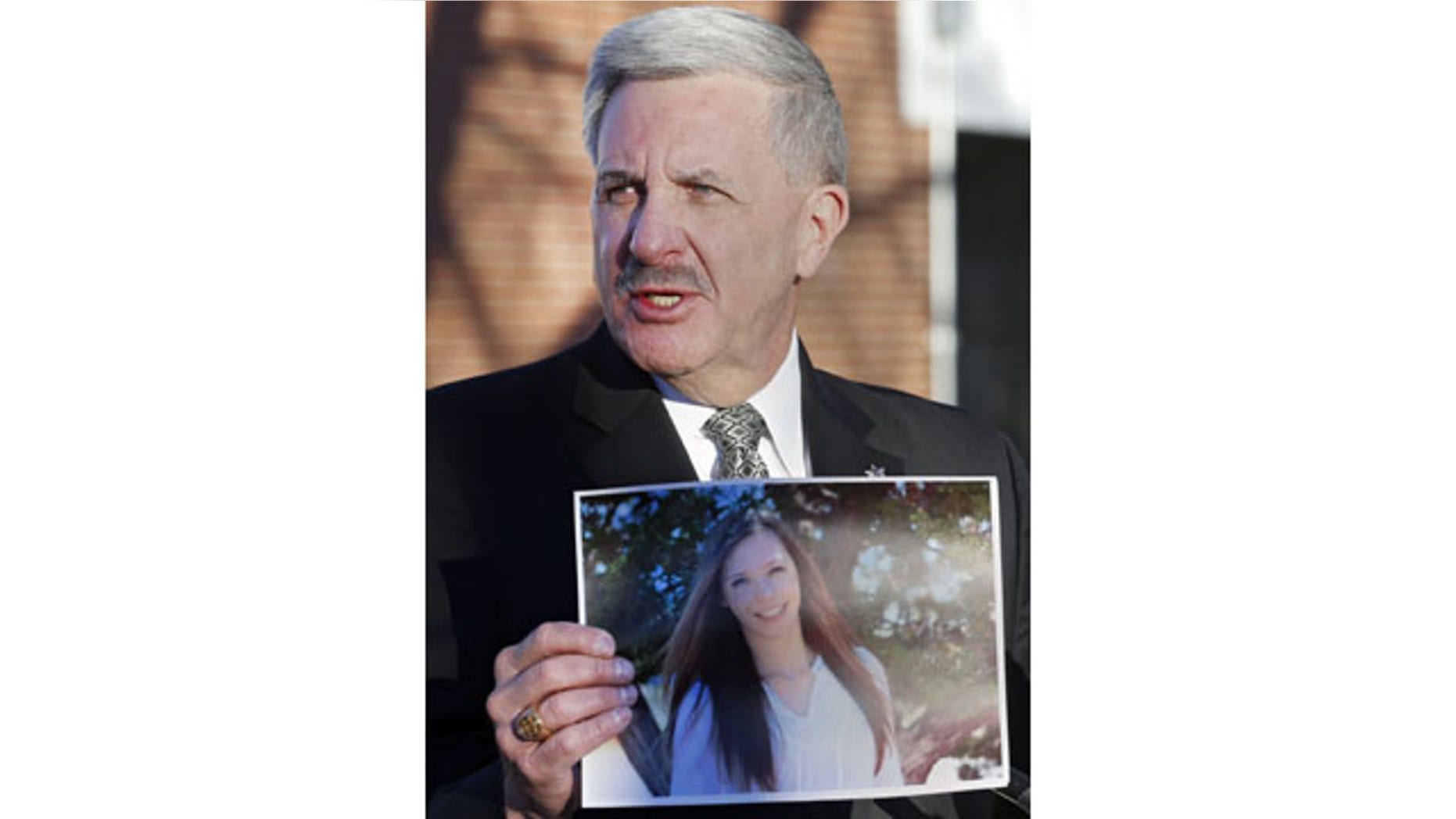 December 14, 2013: Arapahoe County Sheriff Grayson Robinson holds a picture of Claire Davis during a briefing, at Arapahoe High School in Centennial, Colo. Davis was shot by 18-year-old shooting suspect Karl Halverson Pierson at the school on Friday before he took his own life. (AP Photo/Ed Andrieski)