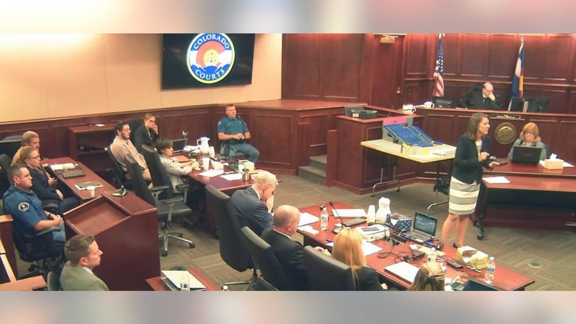 In this image taken from video, defense attorney Tamara Brady, right, gestures during closing arguments in the sentencing phase of the James Holmes trial, in Centennial, Colo., Thursday, Aug. 6, 2015. Holmes sits second from left in a light shirt. (Colorado Judicial Department via AP, Pool)