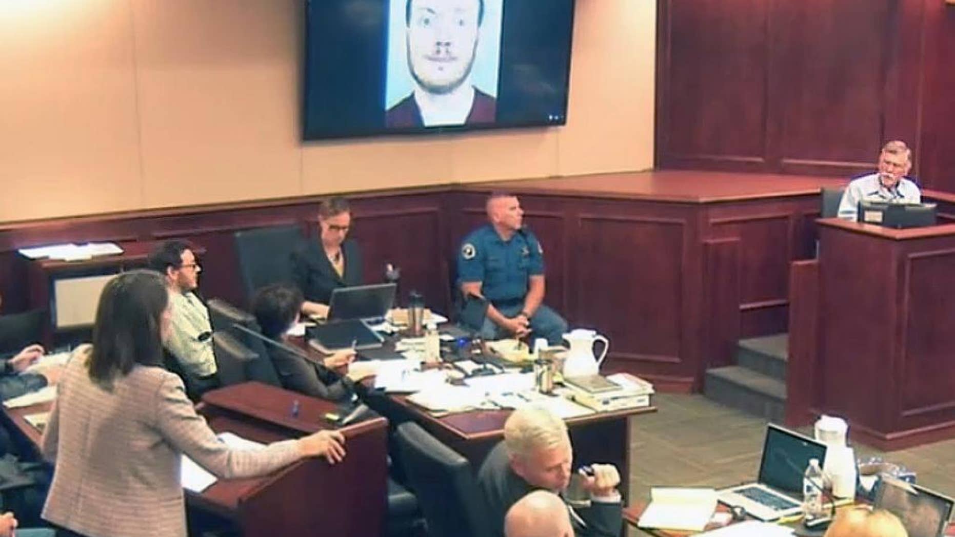 Defense attorney Tamara Brady, left, questions Robert Holmes, top right, the father of James Holmes, background left, during the sentencing phase of the Colorado theater shooting trial.