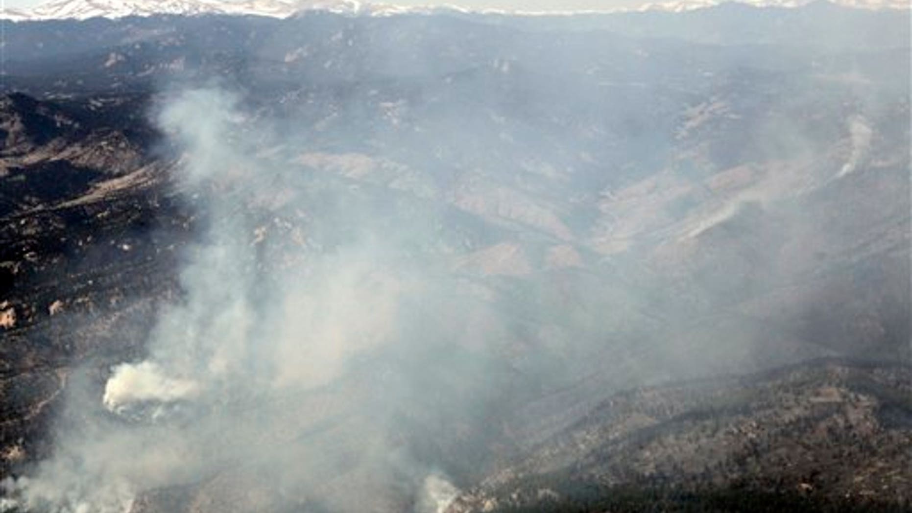 March 27: In this aerial photograph, smoke roils skyward from hot spots as the Lower North Fork Wildfire burns near the foothills community of Conifer, Colo., southwest of Denver.