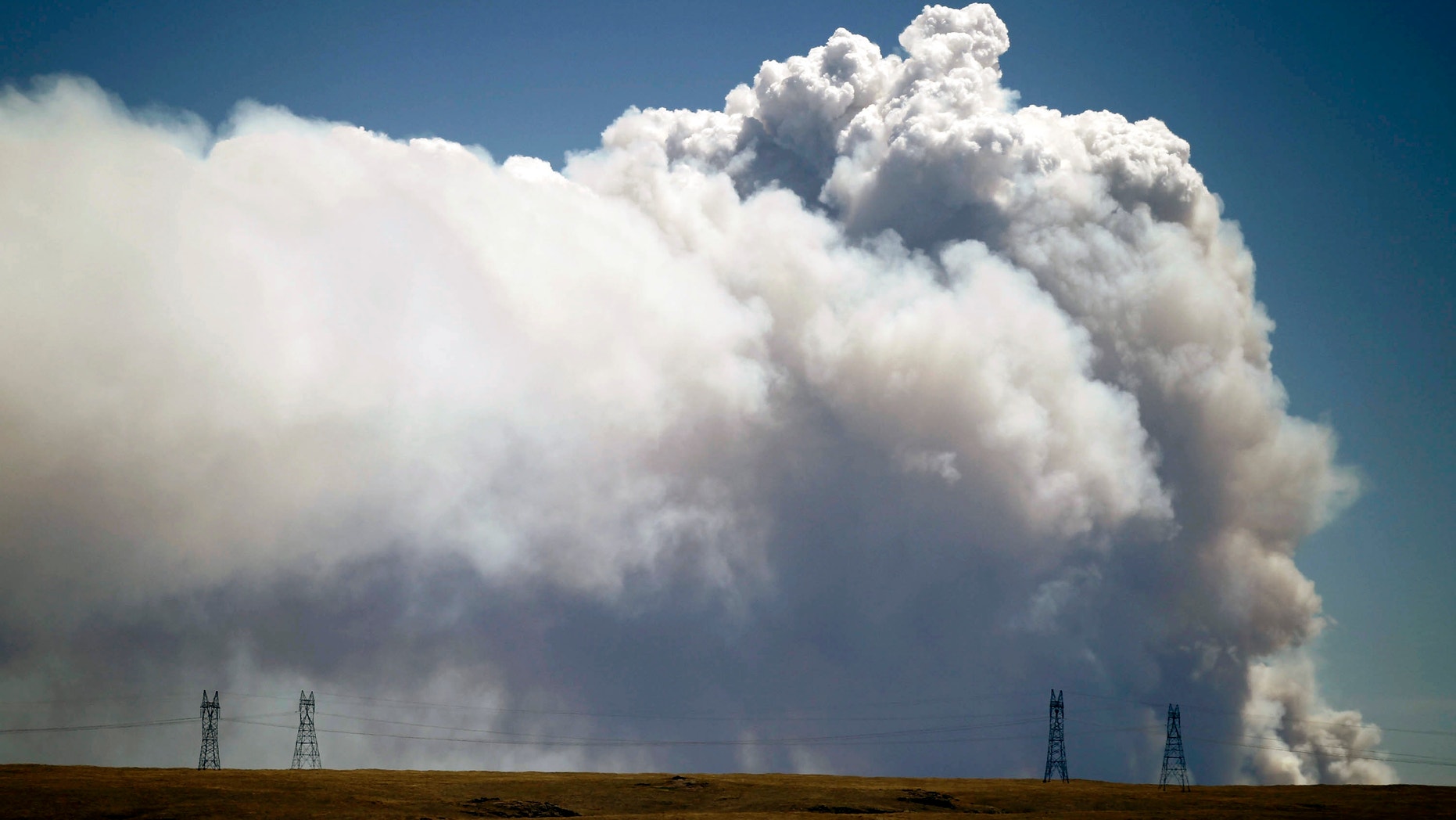 June 9, 2012: Smoke is visible from Tie Siding, Wyo., as a wildfire burns northwest of Fort Collins, Colo.