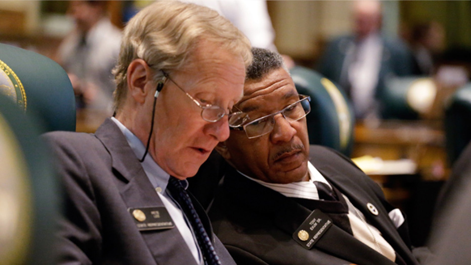 March 11, 2013: Rep. Pete Lee, D-Colorado Springs, left, Rep. Tony Exum, D- Colorado Springs confer as the Civil Unions Bill is debated in the House Chamber at the Capitol.