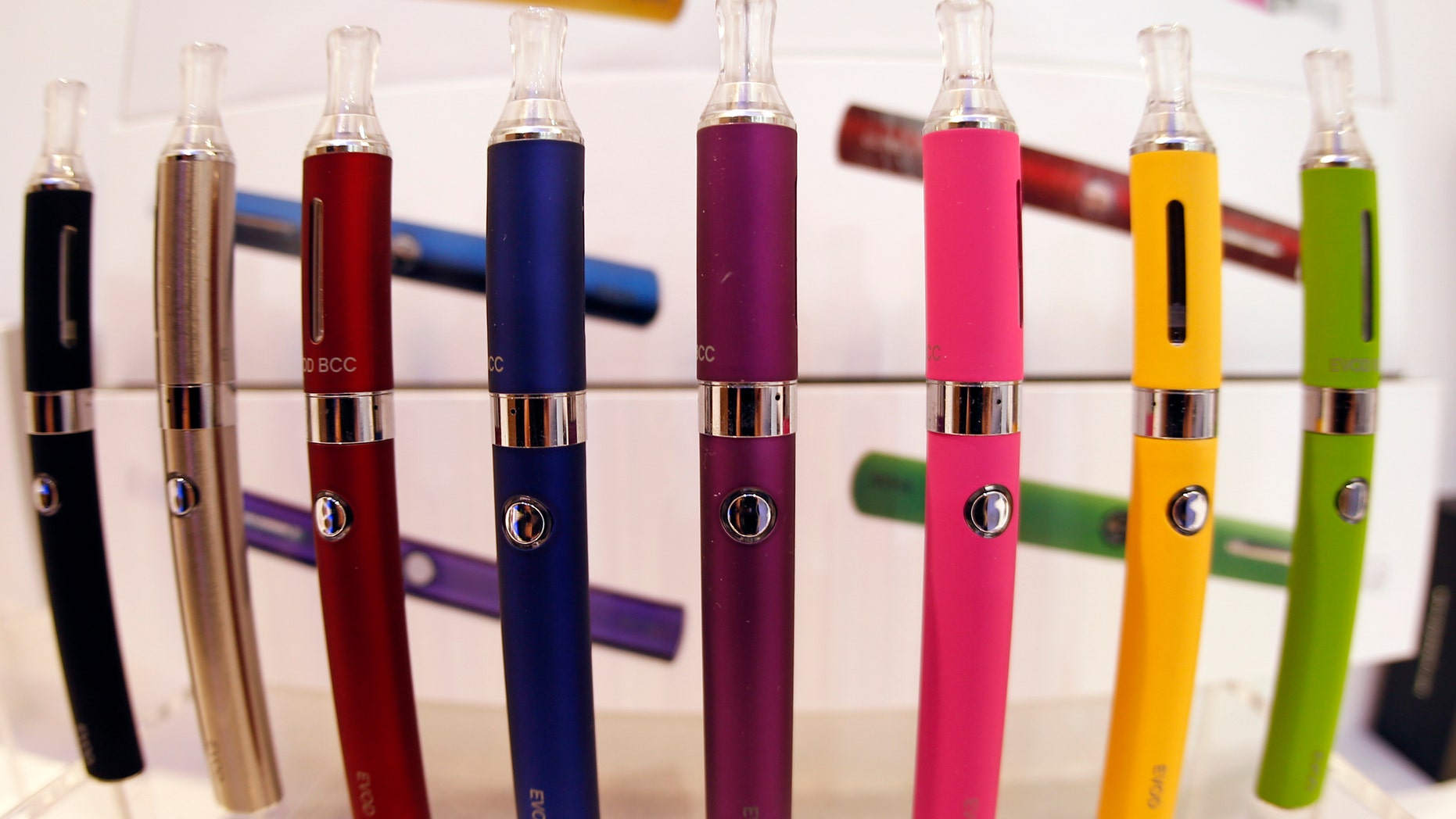 A window display with different color models of electronic cigarettes.