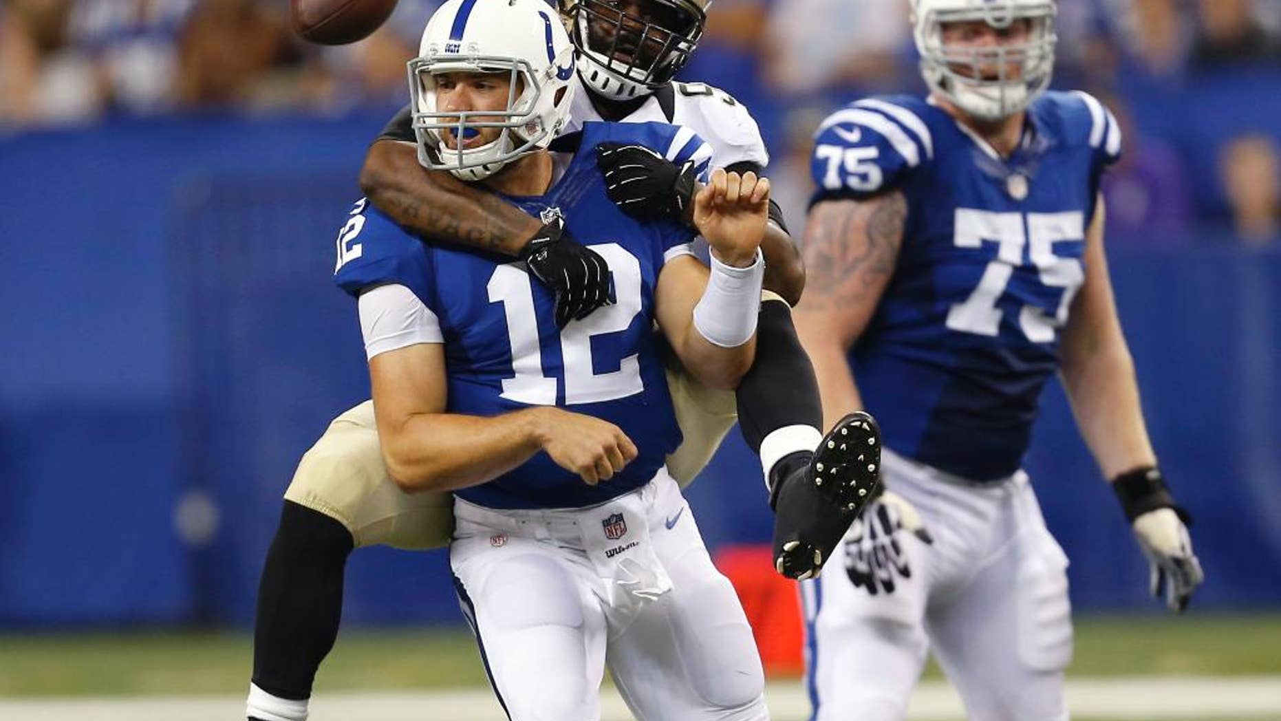 FILE - In this Aug. 23, 2014, file photo, Indianapolis Colts quarterback Andrew Luck (12) loses the ball as he's sacked by New Orleans Saints outside linebacker Junior Galette during the first half of an NFL preseason football game in Indianapolis. The Colts aren't be sure what the offensive line will look like Sunday, Sept. 7, against Denver. (AP Photo/Sam Riche)