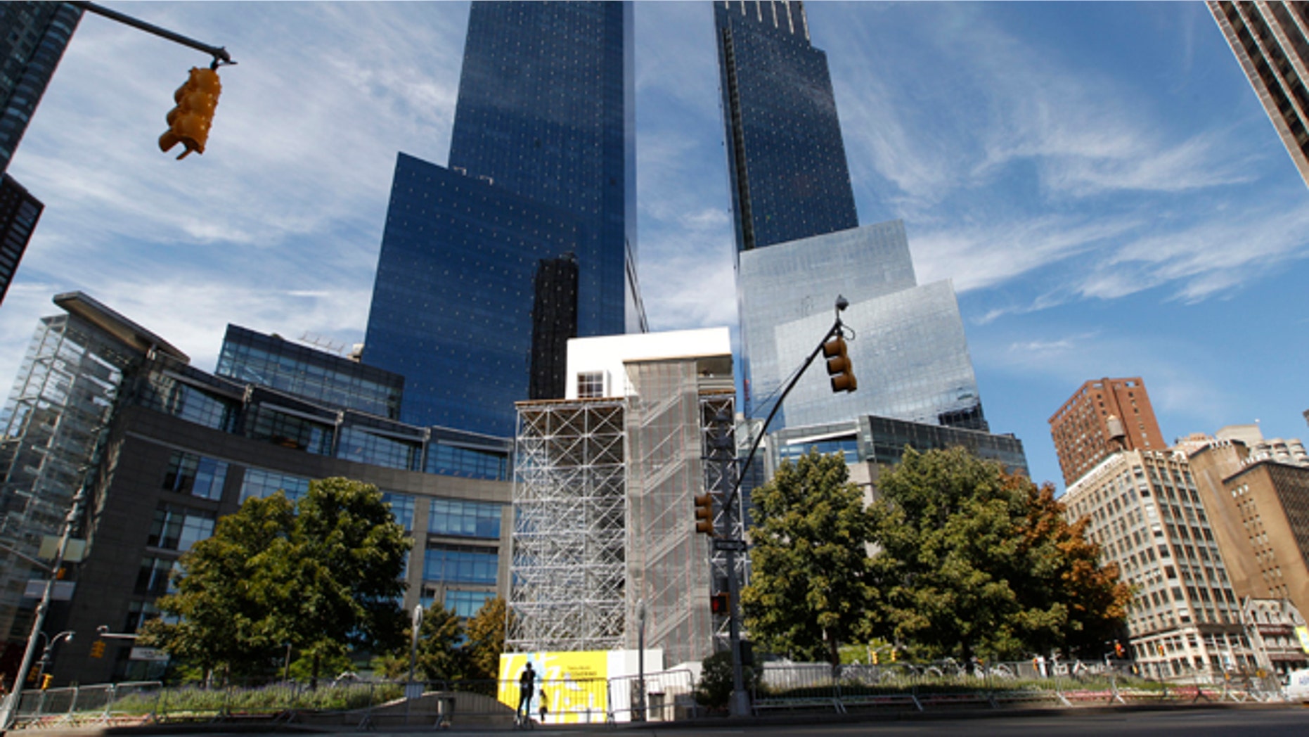 Scaffolding and living room structure surround the base and statue of Christopher Columbus.