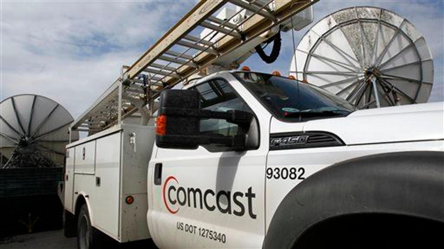 In this Thursday, April 25, 2013, photo, a Comcast truck is parked in Berlin, Vt.