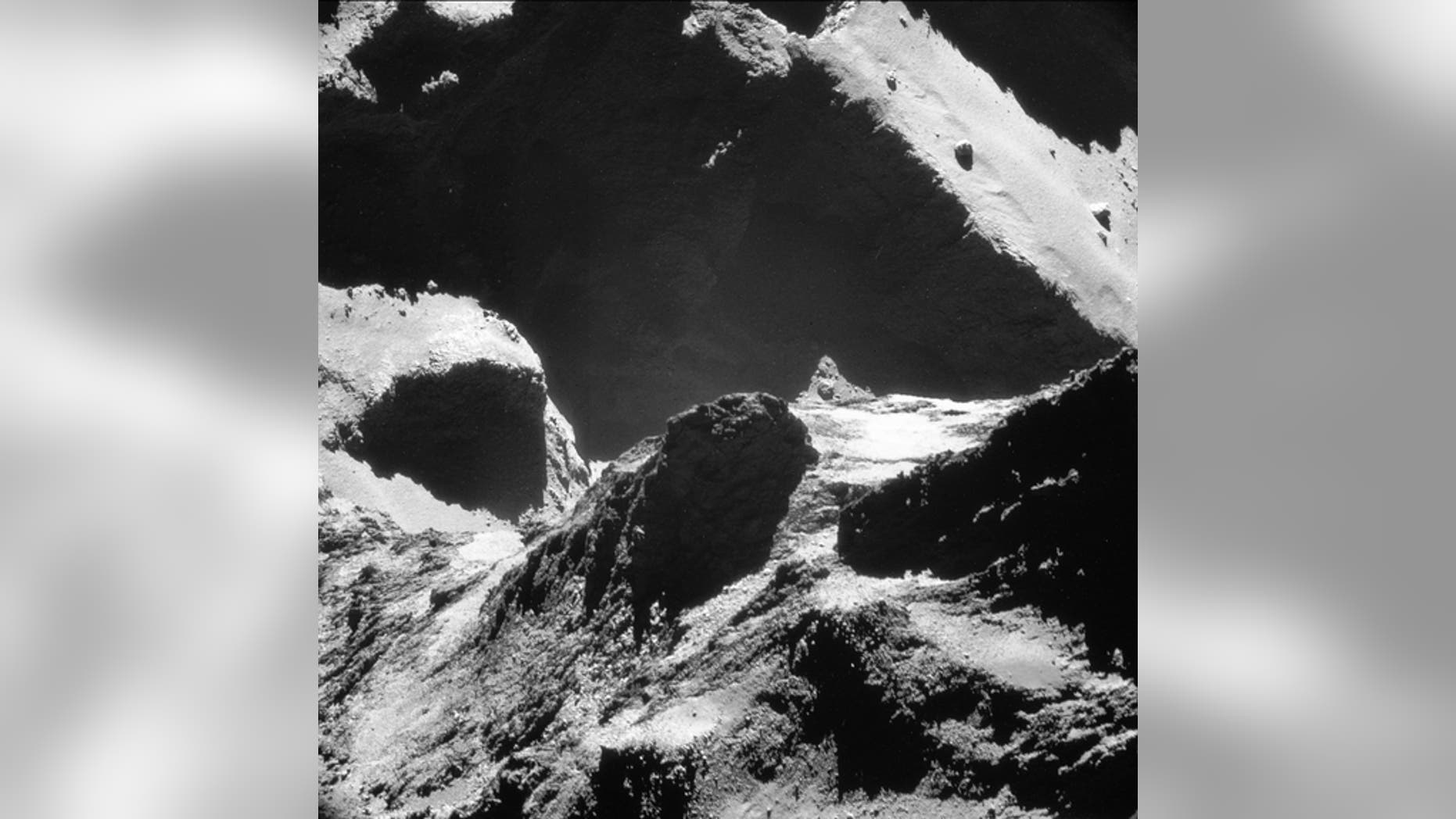 This single-frame Rosetta navigation camera image of Comet 67P/Churyumov-Gerasimenko was taken on October 19, 2014, at a distance of approximately 4.9 miles (7.9 km) from the comet's surface and released on May 28. The image looks across the ne