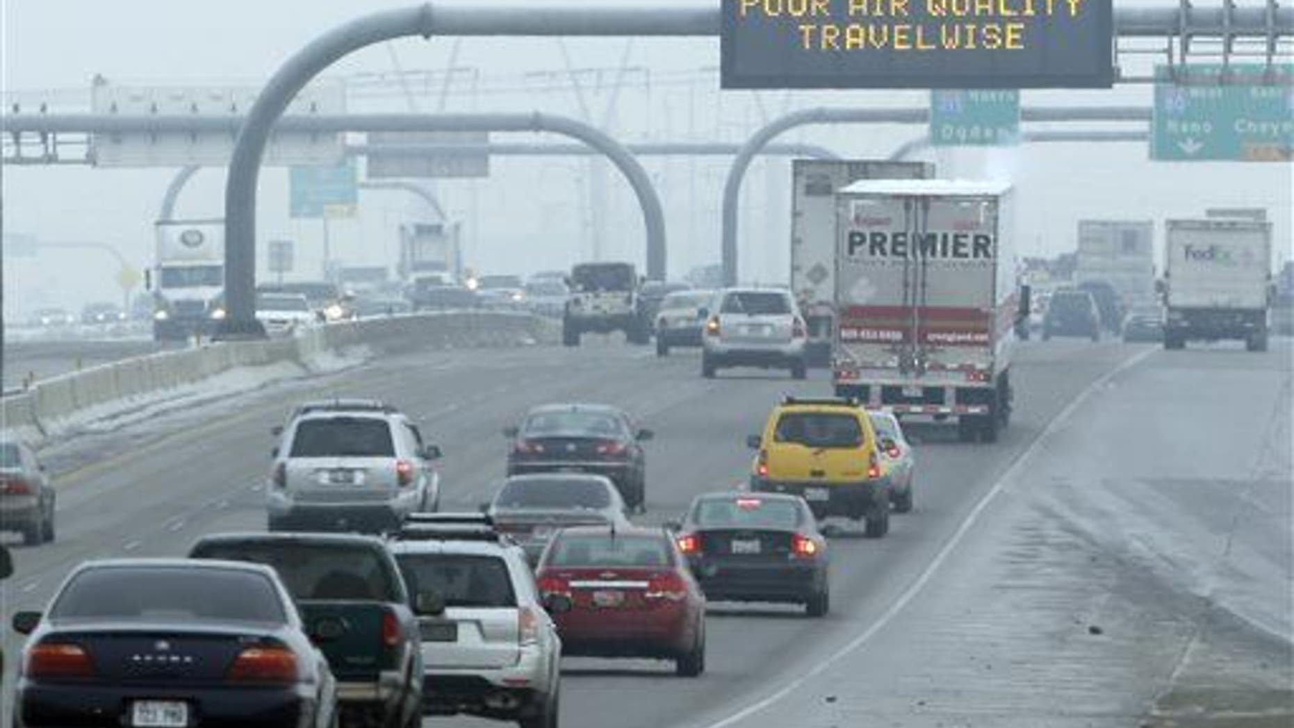 This Jan. 23, 2013, file photo, shows a poor air quality sign is posted over a highway, in Salt Lake City.