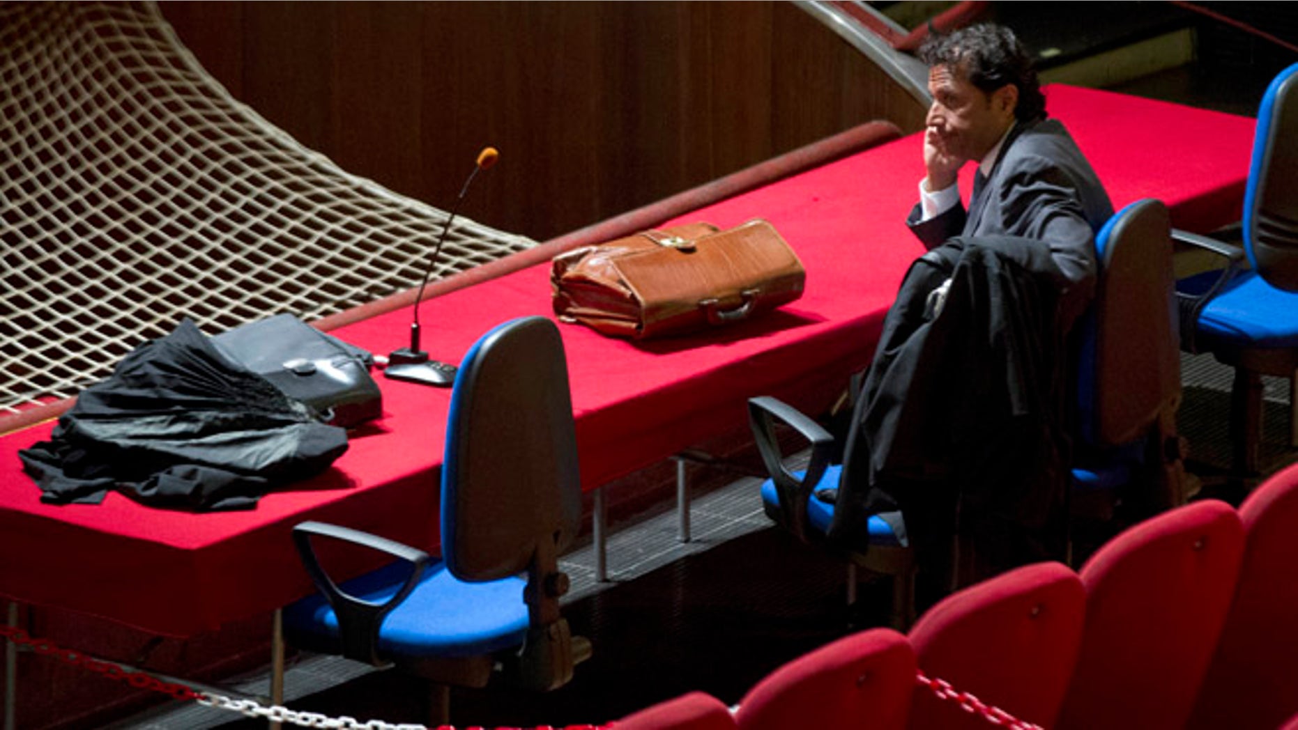 July 17, 2013: Captain Francesco Schettino waits for the start of his trial in the court room of the converted Teatro Moderno theater, in Grosseto, Italy.