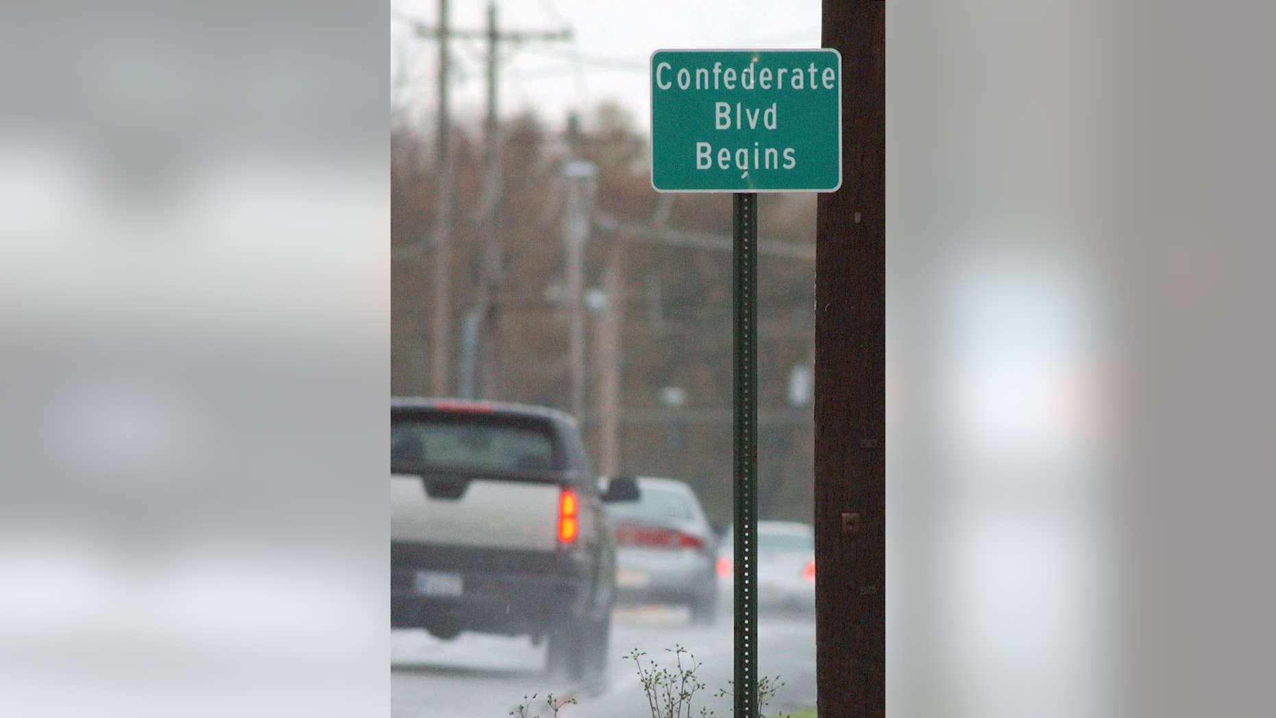 FILE - In this Nov. 29, 2004 file photo, traffic passes a road sign designating Confederate Boulevard near downtown Little Rock, Ark. The Little Rock Planning Commission will consider a request to erase the remaining four blocks of Confederate Boulevard from city maps Thursday, Sept. 24, 2015, the 58th anniversary of 1,200 federal troops arriving in Little Rock to help ensure the integration of Central High School. (AP Photo/Danny Johnston, File)