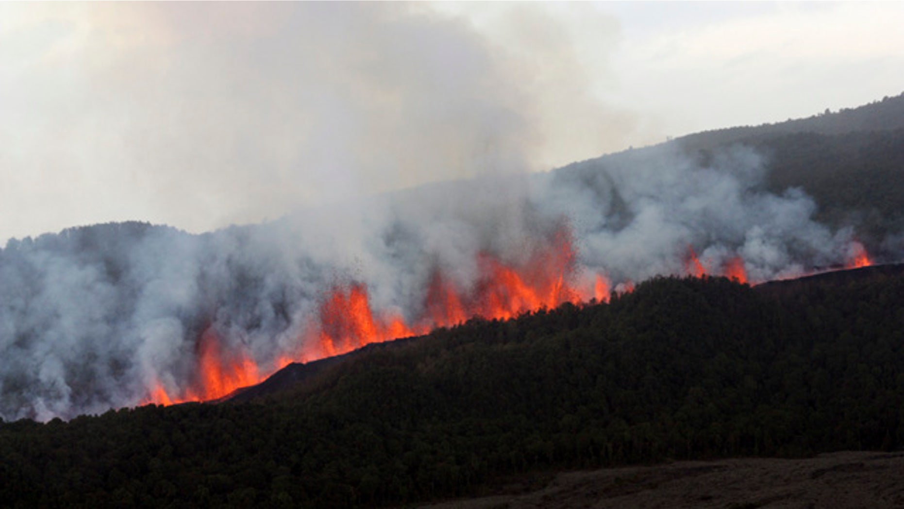 Lava flows down the slope of Nyamulagira volcano 25 miles northwest of Goma, North Kivu, Congo.