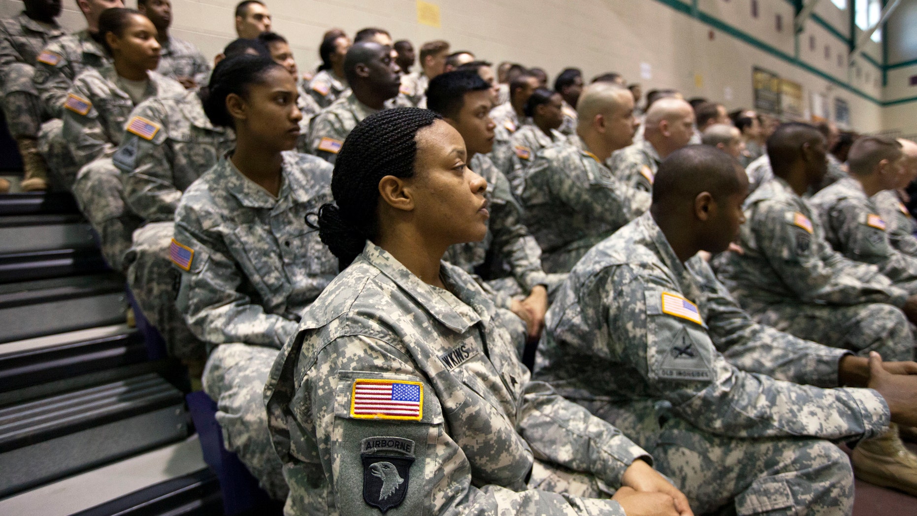 U.S. Army Sgt Dawn Hawkins, foreground, listens to Secretary of Defense Chuck Hagel speak to soldiers about the Army's future during a visit to Fort Eustis, Va., Tuesday, Feb. 25, 2014. Hagel is proposing to shrink the Army to its smallest size in three-quarters of a century, hoping to reshape the military after more than a decade of war in Iraq and Afghanistan and roped in by fiscal constraints set by Congress. (AP Photo/The Virginian-Pilot, The' N. Pham) MAGS OUT