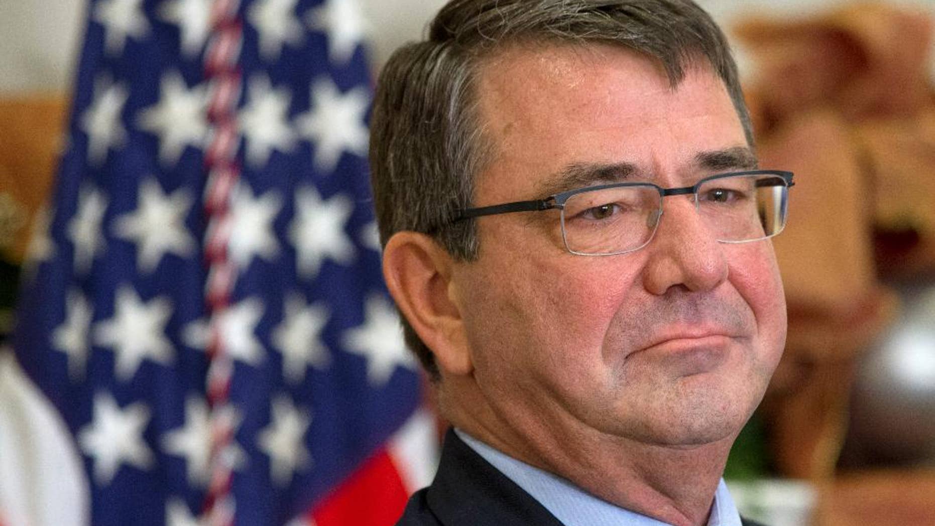 FILE - In this Dec. 5, 2014 file photo, Ashton Carter listens as President Barack Obama announces Carter as his nominee for defense secretary, in the Roosevelt Room of the White House in Washington. The Senate Armed Services Committee is holding a confirmation hearing next week to consider Ashton Carter to be the next secretary of defense. President Barack Obama nominated Carter to succeed Chuck Hagel, who resigned under pressure from Obama.(AP Photo/Jacquelyn Martin, File)