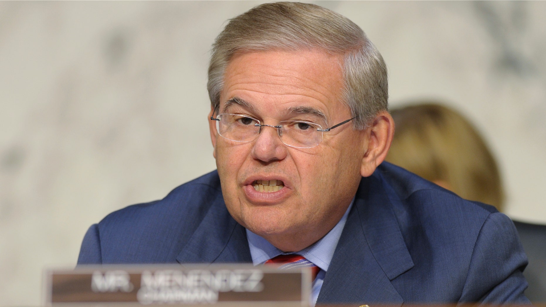 FILE - In this Sept. 4, 2013, file photo, Sen. Robert Menendez, D-N.J. speaks at Capitol Hill in Washington. Key Democratic and Republican senators are crafting legislation to reinstate the full force of Iran sanctions and impose new ones if Tehran doesnât make good on its pledge to roll back its nuclear program, brushing aside the Obama administrationâs fears about upending its diplomatic momentum. Menendez and Sen. Mark Kirk, R-Ill., hope to have the bill ready for other lawmakers to consider when the Senate returns Dec. 9 from its two-week recess, according to legislative aides. (AP Photo/Susan Walsh)
