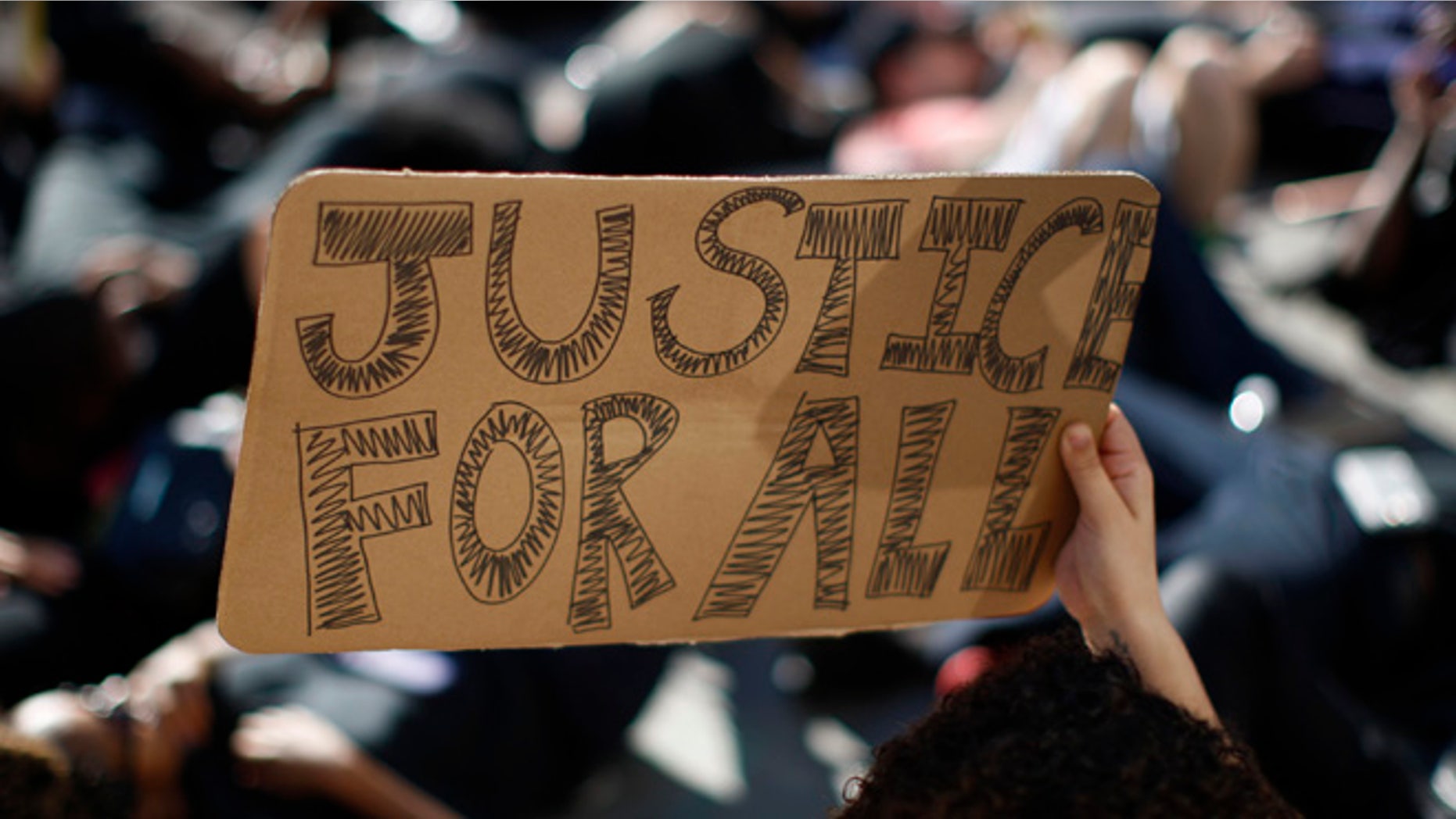LOS ANGELES, CA - DECEMBER 6: People lie down in a die-in on Hollywood Boulevard as they protest of the decision in New York not to indict a police officer involved in the choke-hold death of Eric Garner on December 6, 2014 in the Hollywood section of Los Angeles, California. The march passed the tourist attraction of Hollywood and Highland where police had previously shot and killed a man that according to police had a knife. (Photo by David McNew/Getty Images)