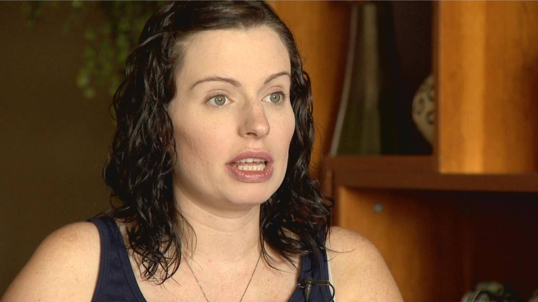 In this Aug. 25, 2015 photo provided by KUSA-TV, expectant mother Amber McCullough is pictured during an interview with Colorado's KUSA-TV, a day before she was to give birth to conjoined twins in Aurora, Colo. McCullough, of Hastings, Minn., was scheduled to deliver twin girls at the Colorado Fetal Care Center at Children's Hospital Colorado by C-section on Wednesday, Aug. 26, 2015. Hospital officials said Wednesday they had no update on the surgery. (KUSA-TV Photo via AP)