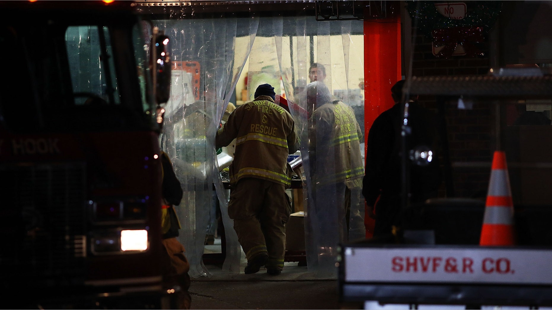 NEWTOWN, CT - DECEMBER 14: A firefighter from the Sandy Hook Fire and Rescue walks into the firehouse near the Sandy Hook School on December 14, 2012 in Newtown, Connecticut. Twenty-seven are dead, including 20 children, after a gunman identified as Adam Lanza in news reports, opened fire in the school. Lanza also reportedly died at the scene. (Photo by Spencer Platt/Getty Images)