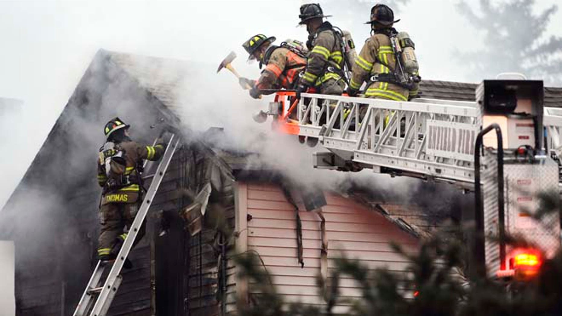 Firefighters control a house fire where fire officials said four people were reportedly unaccounted for, Wednesday, Dec. 10, 2014, in Enfield, Conn., about 20 miles northeast of Hartford. (AP Photo/Journal Inquirer, Jessica Hill) MANDATORY CREDI