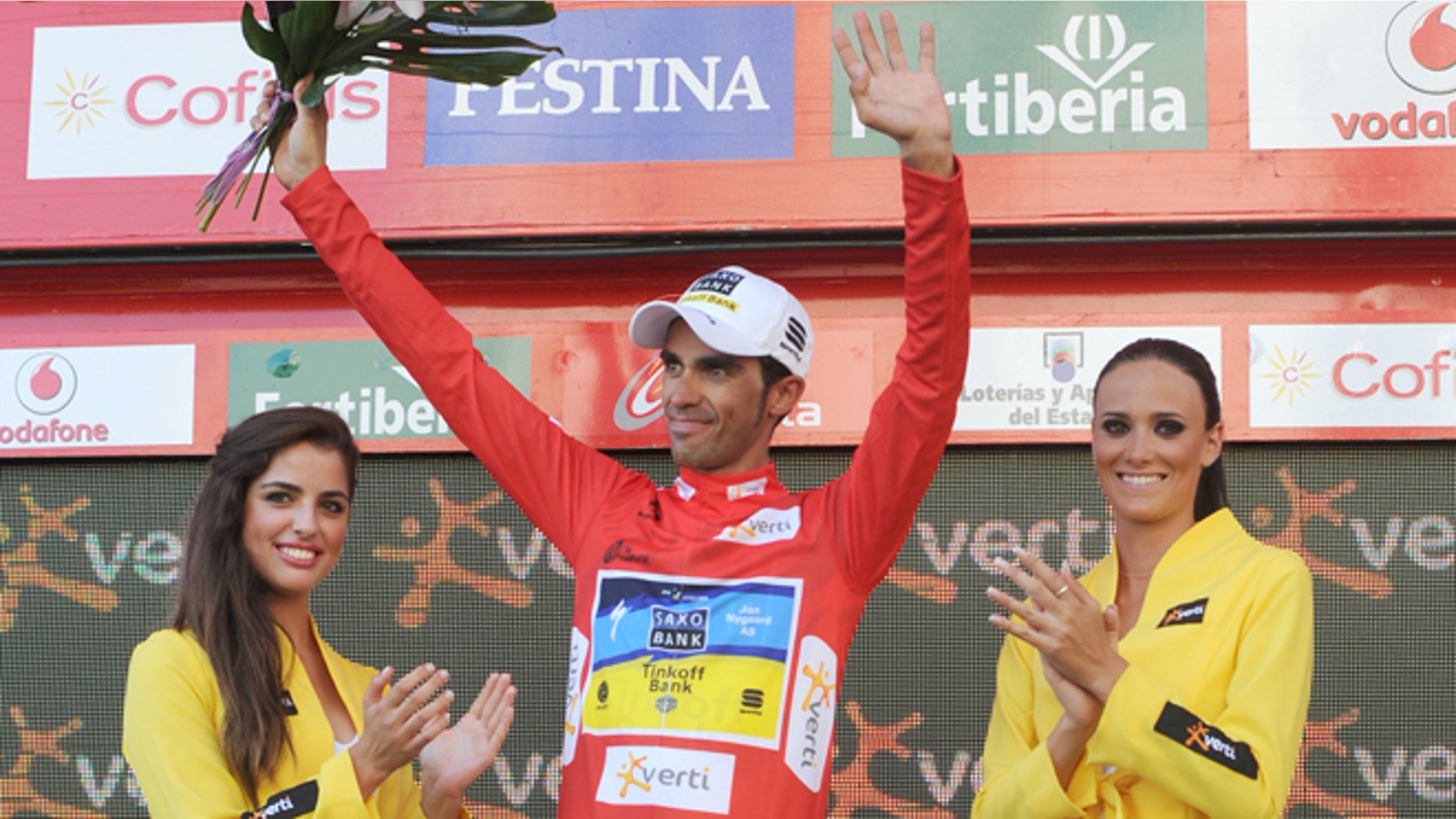 Spanish cyclist Alberto Contador from the Saxo Bank Team celebrates on the podium with the overall red leader jersey at the end of the 18th stage of the Spanish Vuelta cycling race from Aguilar de Campo to Valladolid, Spain, Thursday, Sept. 6, 2012. The 21-stage, three week race ends in Madrid on Sept. 9. (AP Photo/Israel L.Murillo)