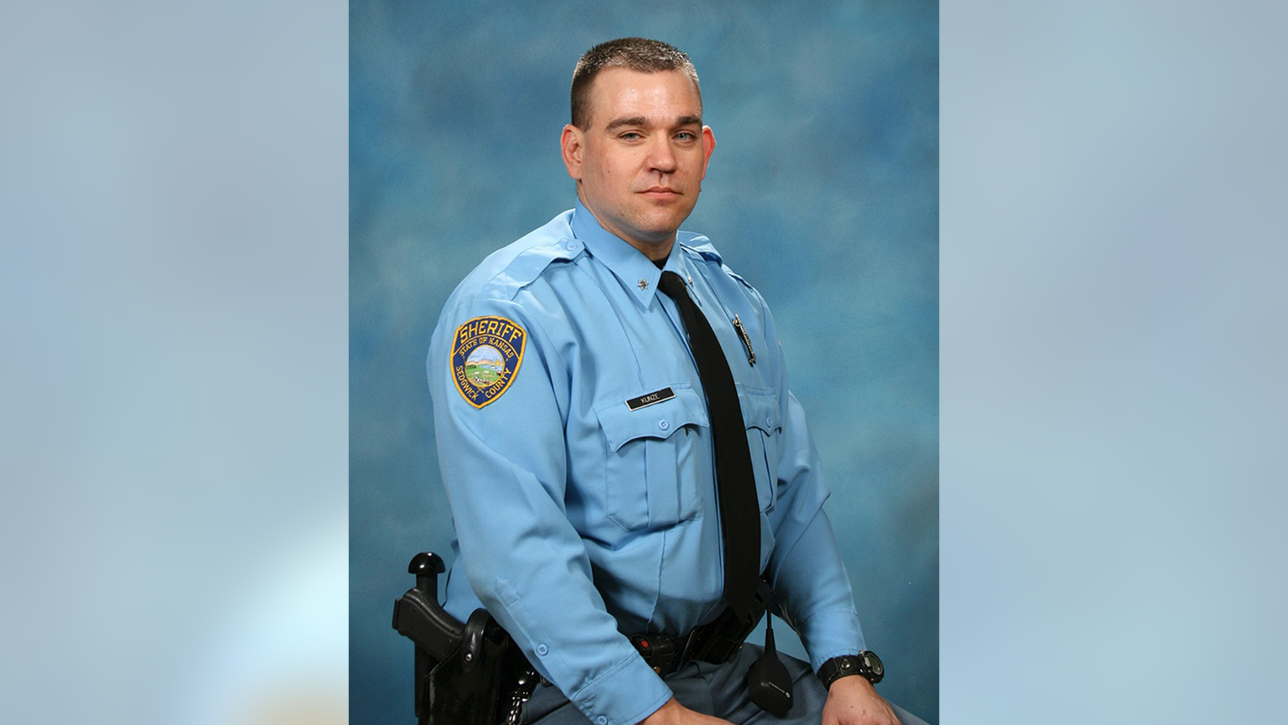 This 2012 photo provided by the Sedgwick County Sheriff's Office in Kansas shows Deputy Robert Kunze, who was shot Sunday, Sept. 16, 2018, after receiving a call about a black truck that had been stolen. Both Kunze and a suspect were killed after a fight broke out as the suspect was being arrested in a rural area of Wichita, authorities say. (Sedgwick County Sheriff's Office via AP)
