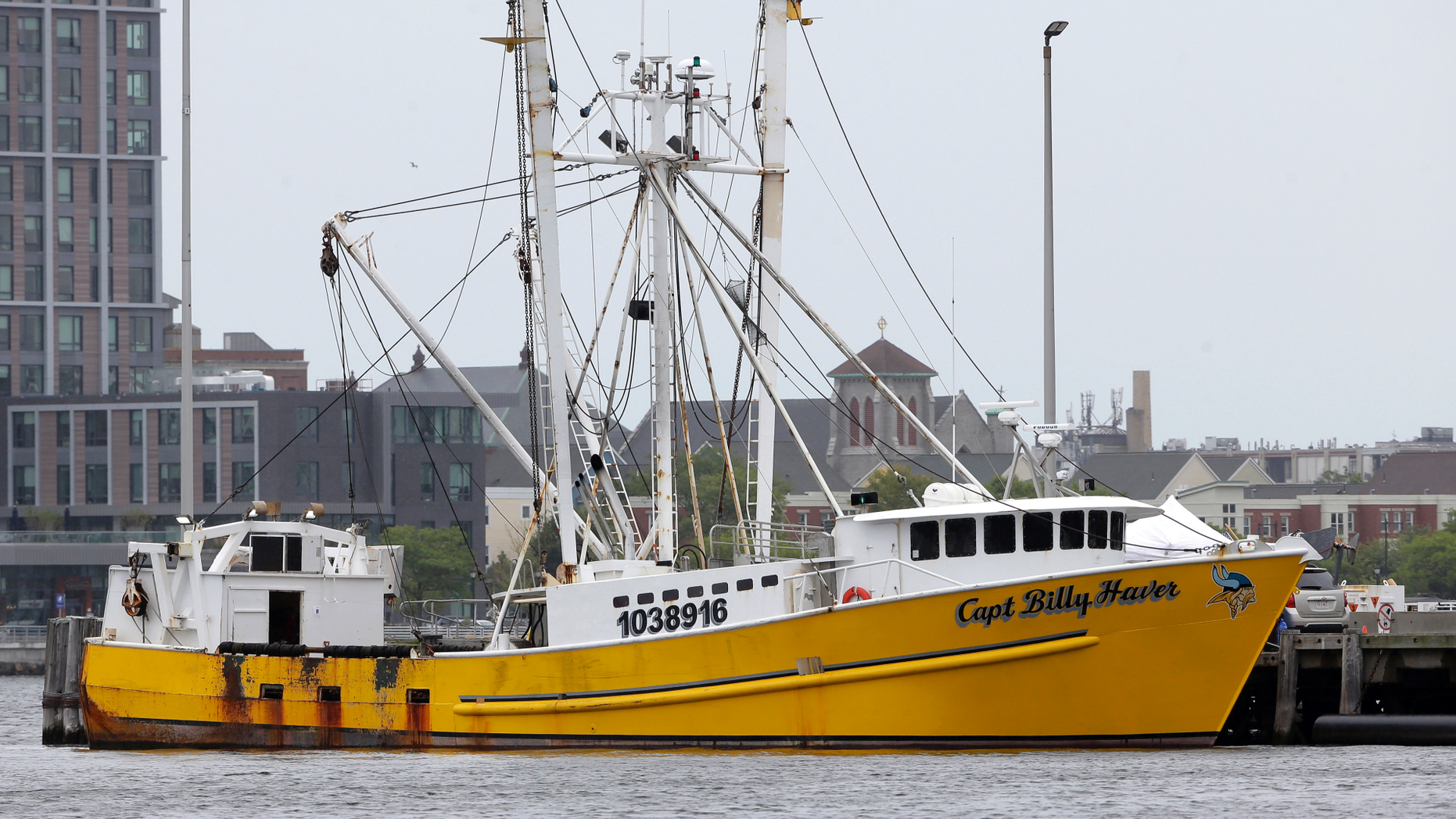 The Virginia-based fishing vessel Captain Billy Haver is docked, Tuesday, Sept. 25, 2018, at the U.S. Coast Guard Station, in Boston. The U.S. attorney's office for Boston said in a statement that crew member Franklin Freddy Meave Vazquez, 27, was charged with murder and attempted murder in connection with an attack Sunday, Sept. 23, 2018 on the fishing vessel while it was underway about 55 miles off Nantucket, Mass. (AP Photo/Steven Senne)