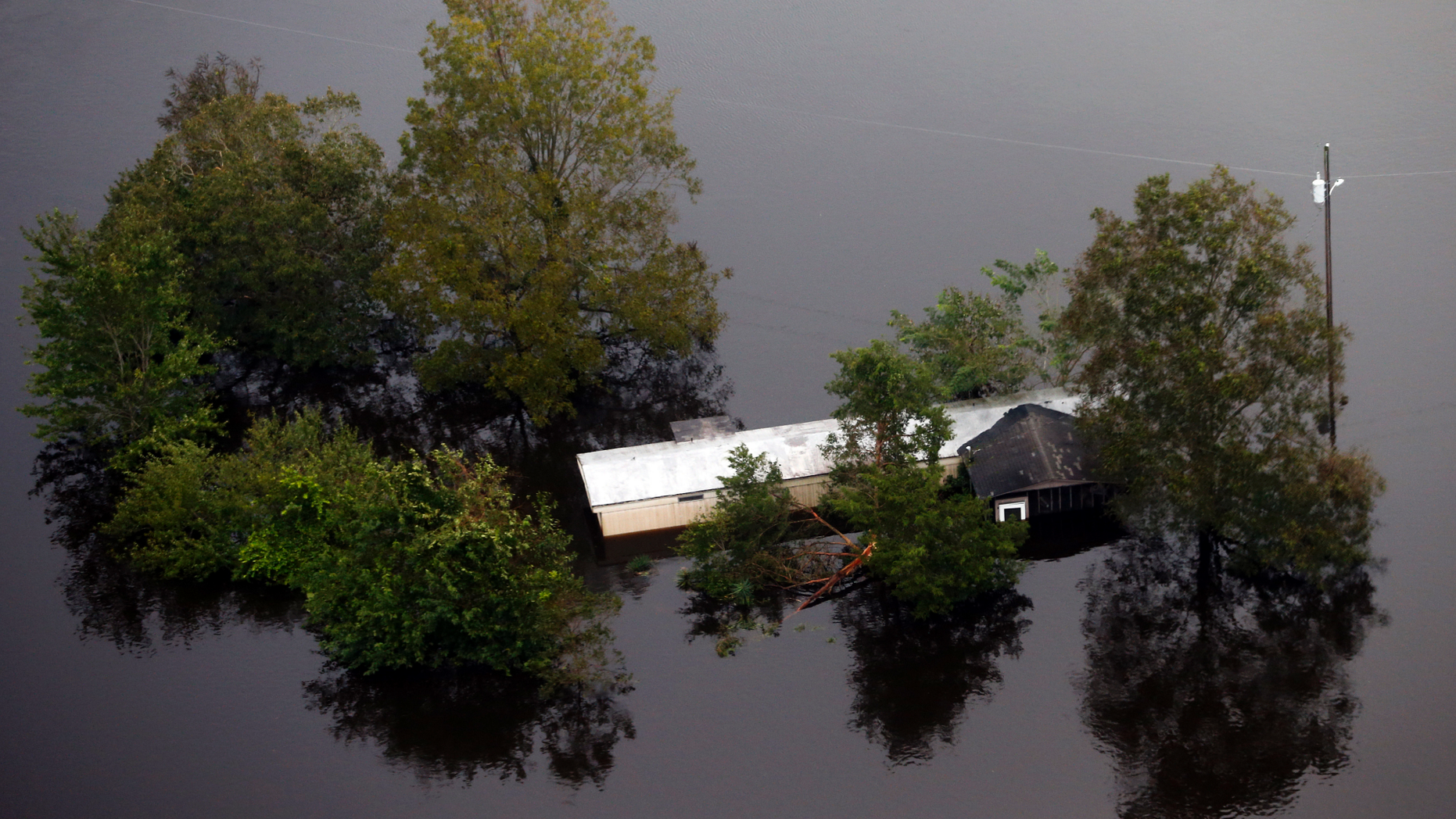 Floodwaters surround a trailer in the aftermath of Hurricane Florence in Pollocksville, N.C., Monday, Sept. 17, 2018. (AP Photo/Steve Helber)