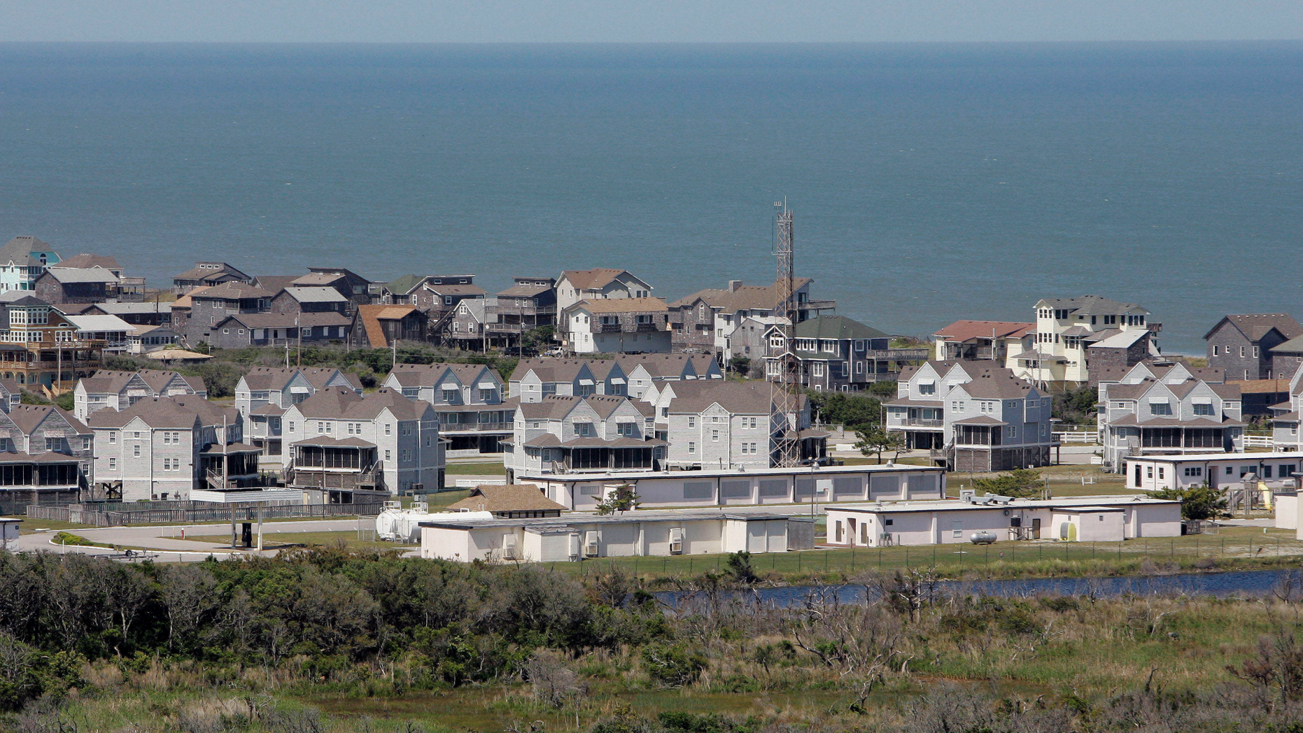 FILE - In this May 15, 2007, file photo, summer vacation and rental properties sit vulnerable beside the ocean, in Buxton N.C. Hurricane Florence has become a reminder of how vulnerable North Carolina's coast is. Experts said Tuesday, Sept. 11, 2018, that the storm could be the state's most destructive on record. (AP Photo/Gerry Broome, File)