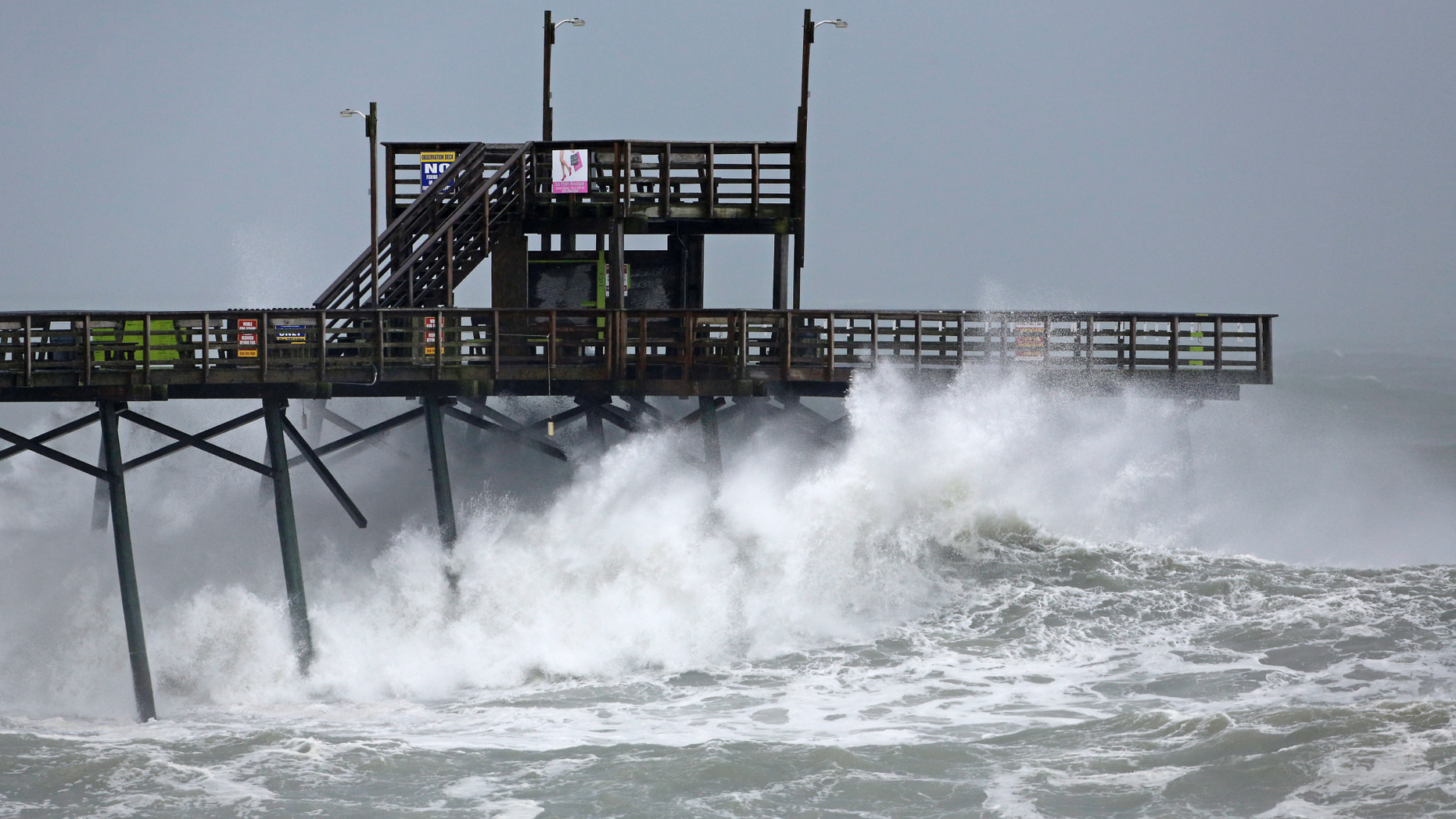 Waves from Hurricane Florence pound the Bogue Inlet Pier in Emerald Isle N.C., Thursday, Sept. 13, 2018. (AP Photo/Tom Copeland)