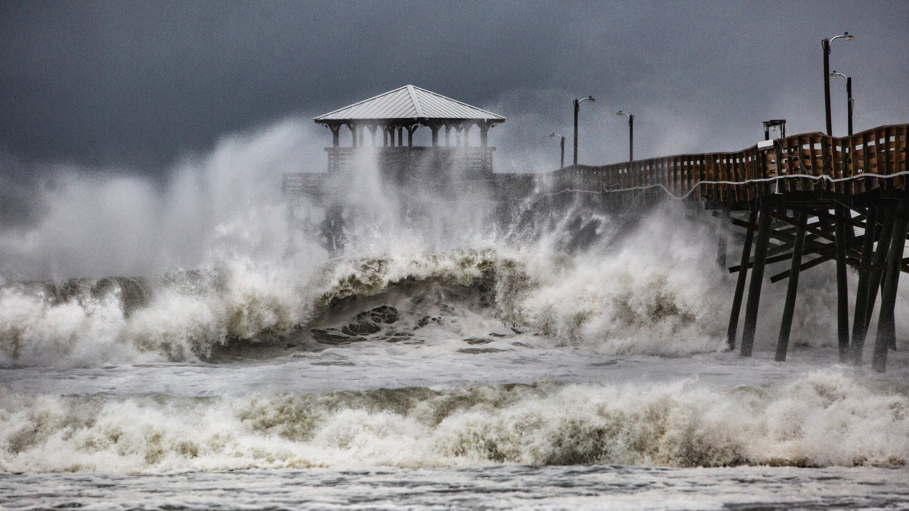 Waves slam the Oceana Pier & Pier House Restaurant in Atlantic Beach, N.C., Thursday, Sept. 13, 2018 as Hurricane Florence approaches the area. (Travis Long/The News & Observer via AP)