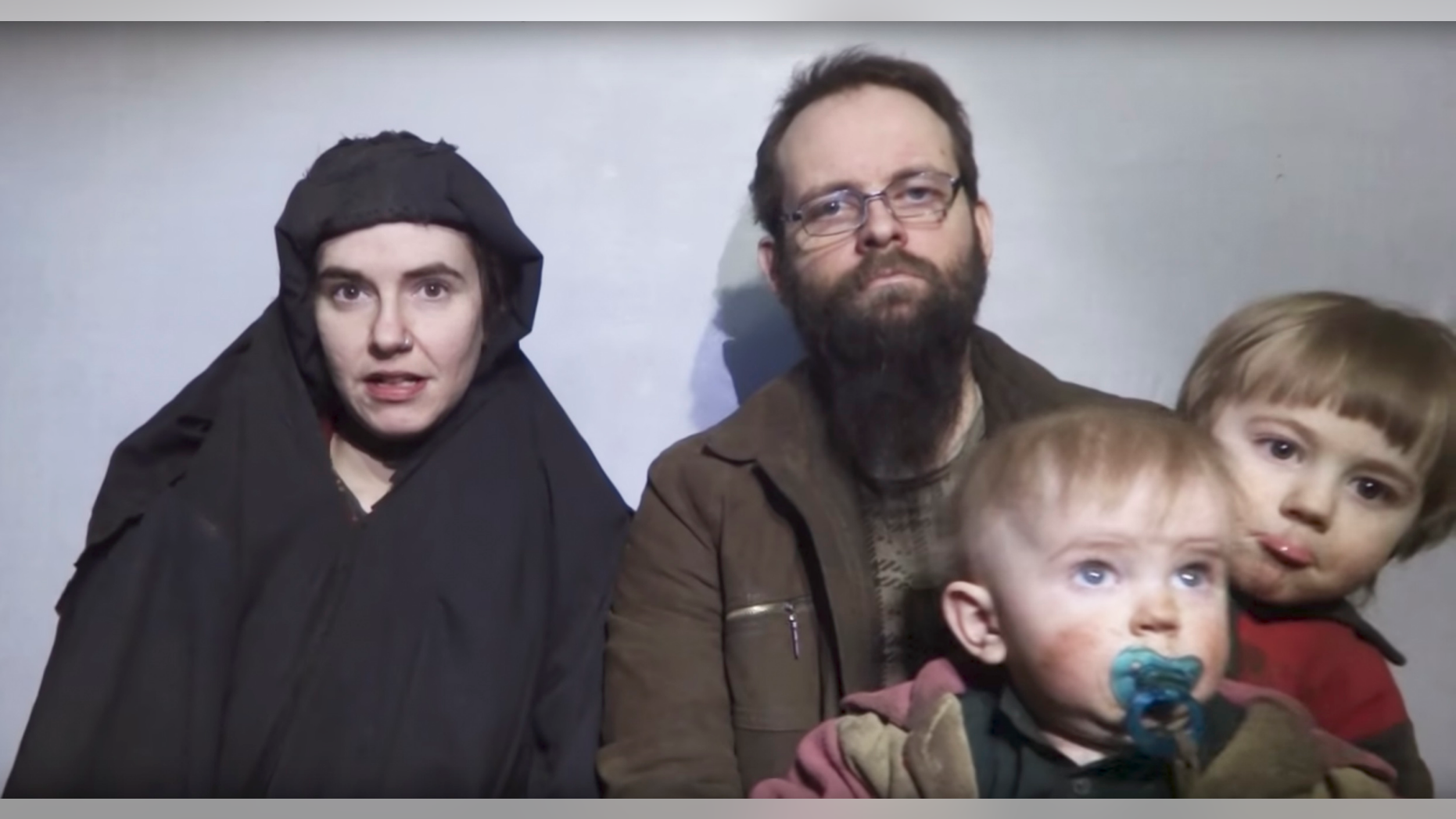 In this file image from video released by Taliban Media in December 2016, Caitlan Coleman talks in the video while her Canadian husband Joshua Boyle holds their two children. (AP)