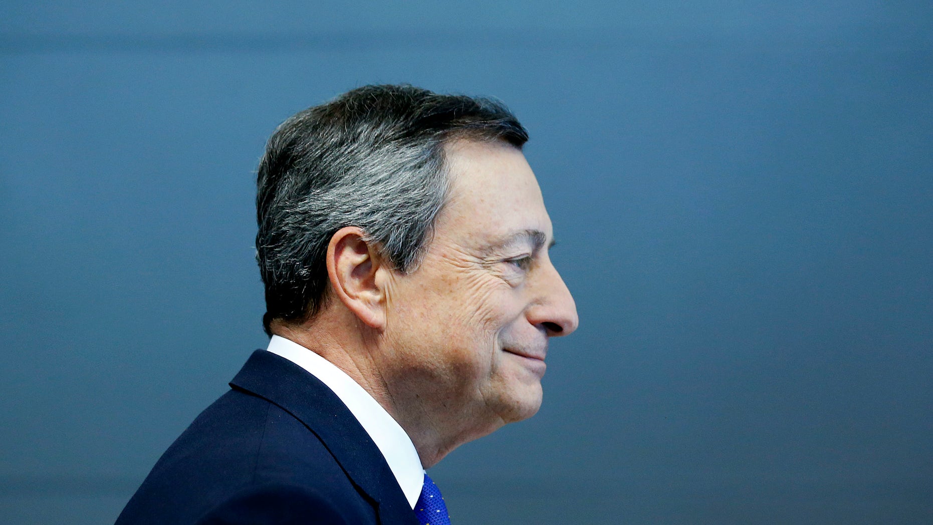 President of the European Central Bank Mario Draghi is on his way to a news conference in Frankfurt, Germany, Thursday, April 27, 2017. (AP Photo/Michael Probst)
