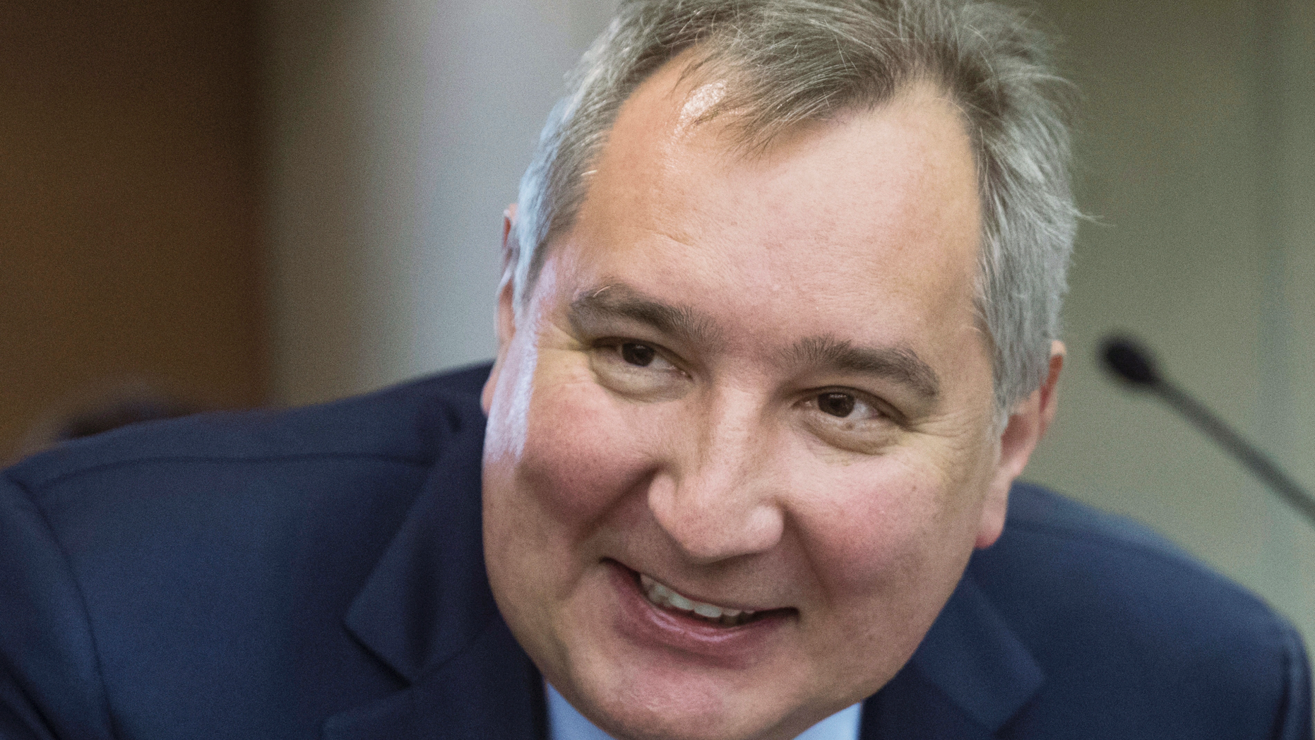 FILE In this file photo taken on Wednesday, April 11, 2018, Russian Deputy Prime Minister Dmitry Rogozin smiles before Russian Prime Minister Dmitry Medvedev's annual report on country's economic and social development in the State Duma, the Lower House of the Russian Parliament, in Moscow, Russia. Rogozin said Saturday, Sept. 22, 2018 that Russia wouldn't accept a second-tier role in a NASA-led plan to build an outpost near the moon, but his spokesman quickly clarified that Russia is staying in the project. (AP Photo/Pavel Golovkin, File)