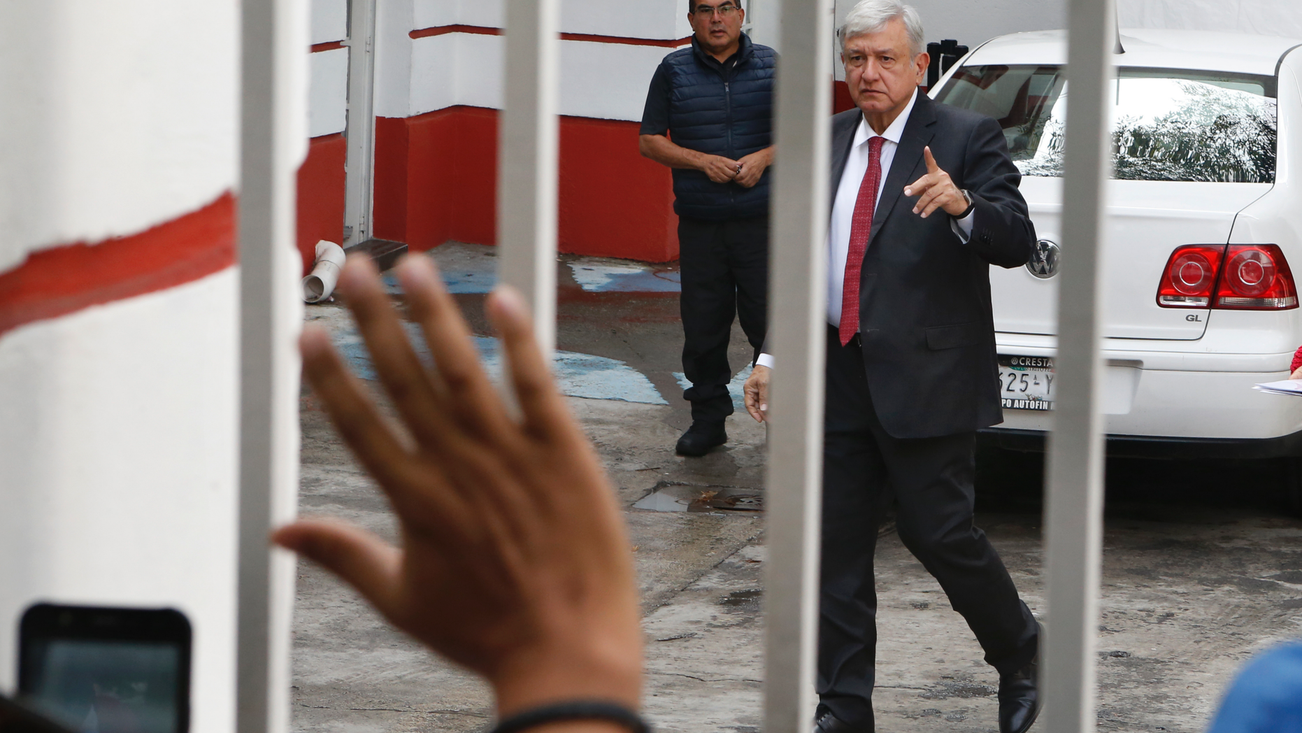Mexico's President-elect Andres Manuel Lopez Obrador greets supporters as he arrives to his party's headquarters in Mexico City, Thursday, Sept. 13, 2018. Lopez Obrador takes office Dec. 1. (AP Photo/Marco Ugarte)