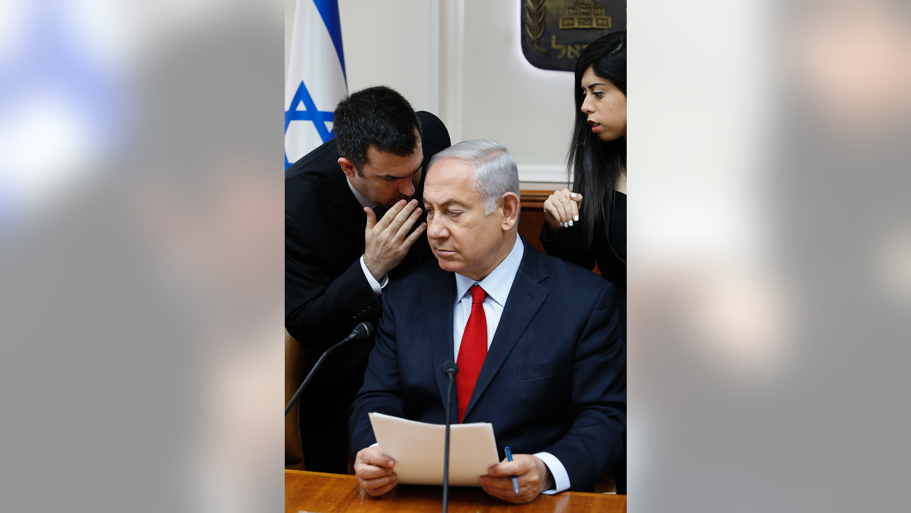 FILE - In this July 23, 2018 file photo, Israeli Prime Minister Benjamin Netanyahu listens to his spokesman David Keyes as he opens the weekly cabinet meeting at his Jerusalem office. An opposition Israeli lawmaker is calling on Netanyahu to suspend Keyes following sexual assault allegations. Michal Rozin, a legislator with the dovish Meretz party, says David Keyes, Netanyahu's spokesman to the foreign media, can no longer represent Israel to the world amid the accusations. (Gali Tibbon/Pool via AP, File)