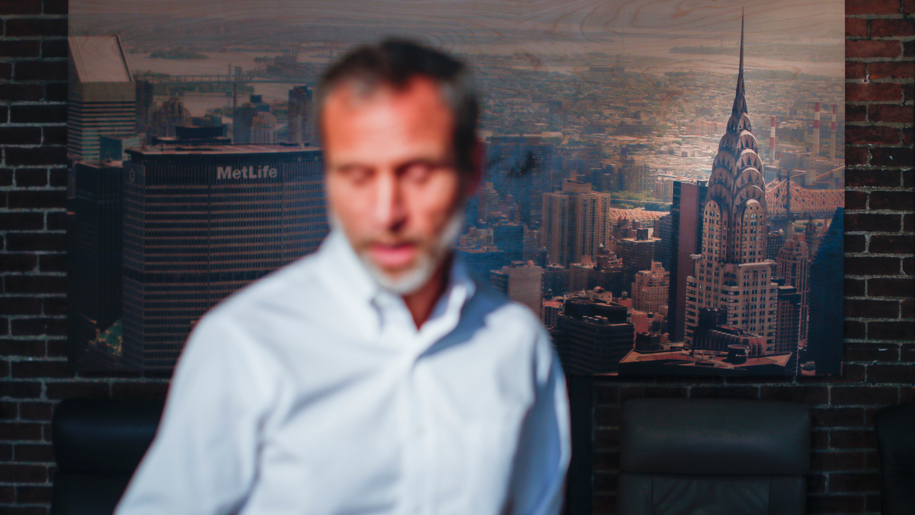 Michael Koveleski, is interviewed in the showroom of their store Design Sleep where an aerial photograph of the Chrysler Building hangs on their wall in Yellow Springs, Ohio on Thursday, Aug. 23, 2018. He and his wife, Margery, left New York in the wake of 9/11 with four children and no work lined up. (AP Photo/John Minchillo)