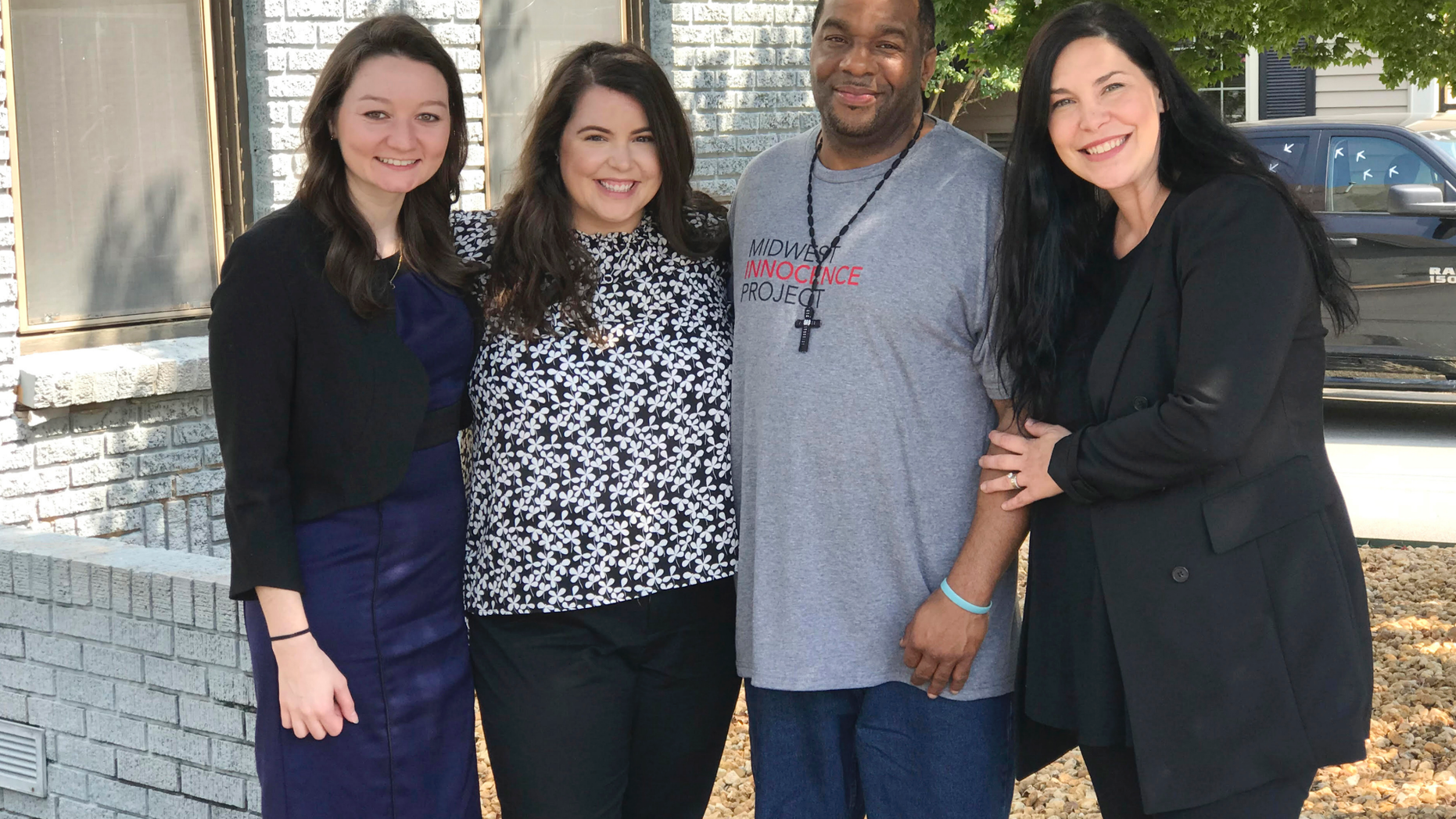 In this photo provided by the law firm Lassiter and Cassinelli, John Brown, second from right, poses with Midwest Innocence Project investigator Blair Johnson, MIP attorney Rachel Wester, and attorney Erin Cassinelli after Brown was released from prison on Wednesday, Sept. 19, 2018, in Little Rock, Ark. In August, a judge overturned Brown's 1992 conviction for the murder and robbery of an elderly woman. The state is appealing the judge's decision and Brown could still be retried. (Jene Louviere/Lassiter and Cassinelli via AP)