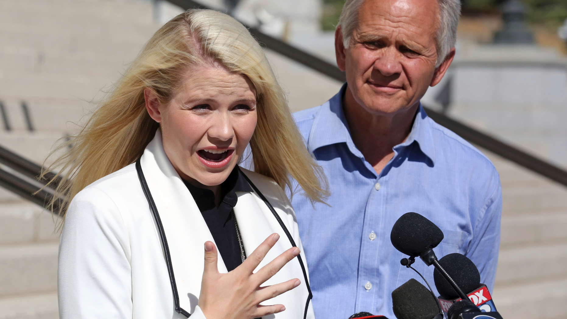 Elizabeth Smart speaks during a news conference while her father Ed Smart looks on Thursday, Sept. 13, 2018, in Salt Lake City. Smart says it appears there is no viable, legal recourse she can take to stop the release of one of her kidnappers. Smart said at a news conference Thursday in Salt Lake City that she only found out about 72-year-old Wanda Barzee's release shortly before the public did. (AP Photo/Rick Bowmer)