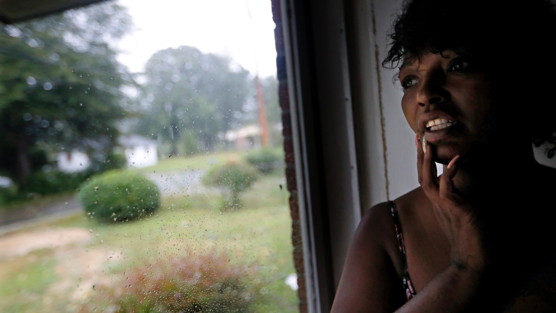 Nichole Worley looks out from her home in Lumberton, N.C., Friday, Sept. 14, 2018, as rains from Hurricane Florence threaten the neighborhood with flooding. Two years ago, Worley’s house, and most of the houses around her, took in water up to its eaves during Hurricane Matthew. “I don’t think we can stand another one,” she says. “I can’t do this again.” (AP Photo/David Goldman)