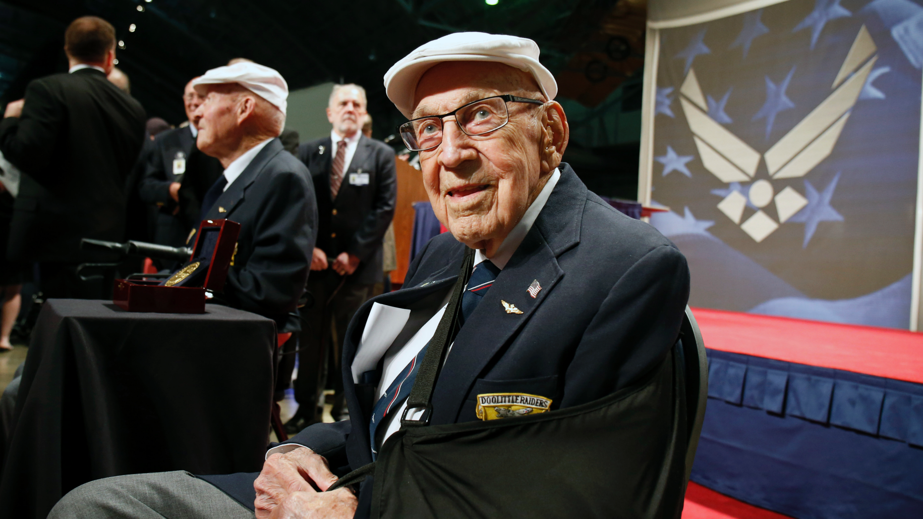 Two members of the Doolittle Tokyo Raiders, retired U.S. Air Force Lt. Col. Richard "Dick" Cole, seated front, and retired Staff Sgt. David Thatcher, seated left, pose for photos after the presentation of a Congressional Gold Medal. Cole, the unit's last surviving member, has died. (AP Photo/Gary Landers, File)