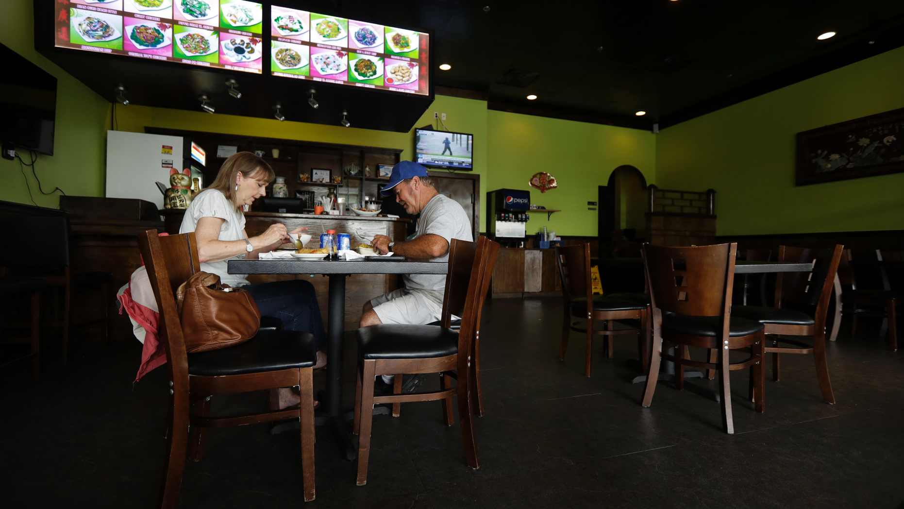Sharon and Sammy Edwards, of Rocky Point, N.C., eat lunch at one of only a few restaurants open in Wilmington, N.C., as Hurricane Florence threatens the coast Thursday, Sept. 13, 2018. The Edwards' left their home north of Wilmington to ride out the storm with Sammy's brother in Wilmington, who has a generator. (AP Photo/Chuck Burton)