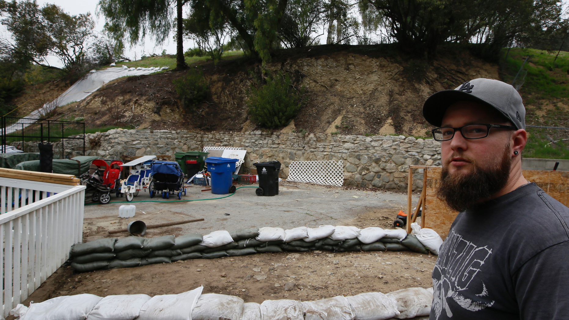 Andrew Joos-Visconti protects his home from the upcoming rains with sand bags in the Sun Valley area of Los Angeles Tuesday, March 20, 2018.