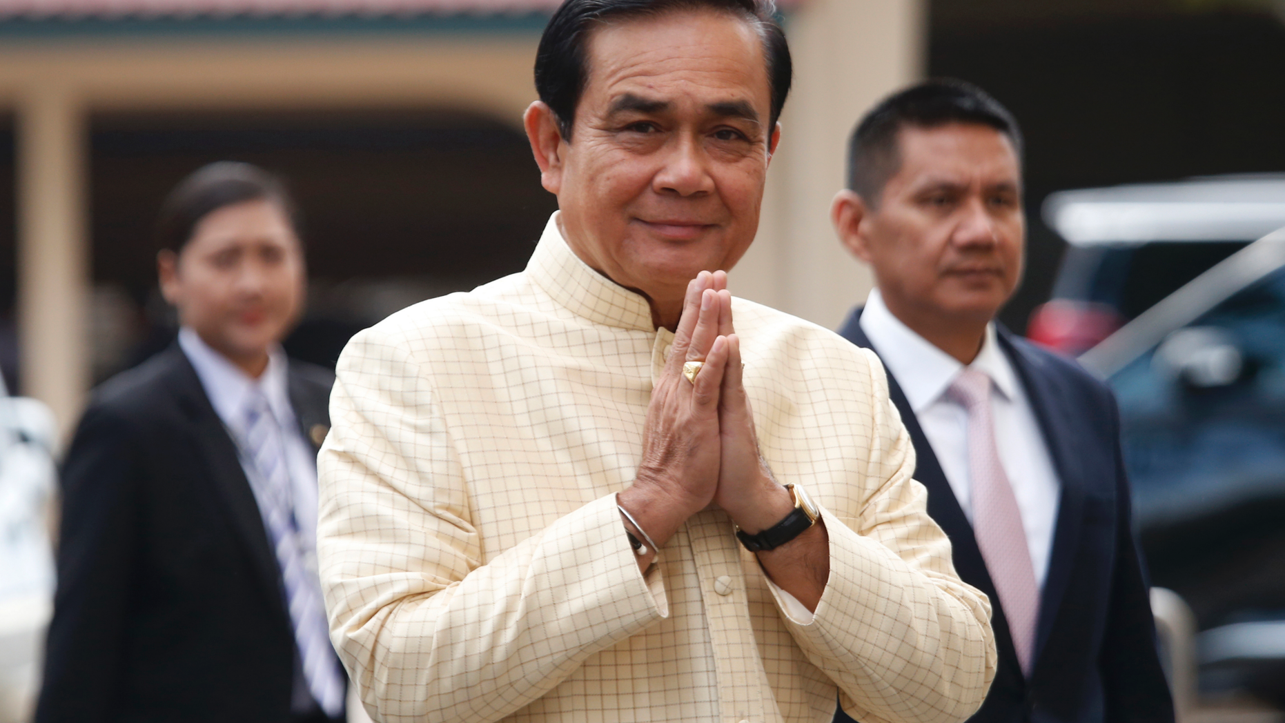 FILE - In this Tuesday, Sept. 11, 2018, file photo, Thai Prime Minister Prayuth Chan-ocha, center, arrives at the government house for a cabinet meeting in Bangkok, Thailand. Prayuth on Monday declared that he is “interested” in the country’s politics, providing further indication that he will run in elections scheduled for early next year. (AP Photo/Sakchai Lalit, File)