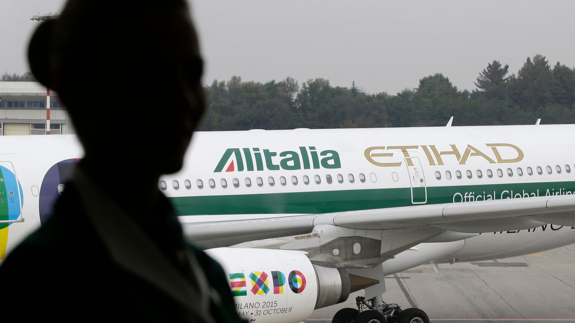 FILE - In this Monday, Oct. 20, 2014 file photo, an Alitalia plane waits on the tarmac of the Malpensa international airport, in Milan, Italy. Alitalia says it’s still flying normally for now, after employees rejected a government-brokered deal of salary cuts and layoffs cuts aimed at avoiding bankruptcy for Italy’s financially troubled flagship airline. (AP Photo/Antonio Calanni, File)