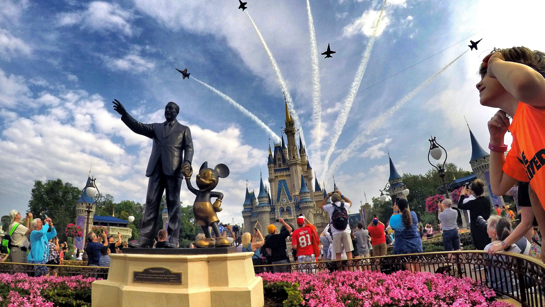 FILE- In this April 16, 2017 file photo, the Blue Angels, the U.S. Navy's legendary flight performance squadron, fly in formation over Cinderella Castle and the 'Partners' statue at the Magic Kingdom at Walt Disney World, in Bay Lake, Fla. Florida emergency officials said Thursday, Sept. 13, 2018, they had no way of tracking how many residents from the Carolinas had escaped to Florida this week. But some hotels were offering special discounts for evacuees and Florida ports were opening their terminals to cruise ships making unexpected ports of call.(Joe Burbank/Orlando Sentinel via AP, File)