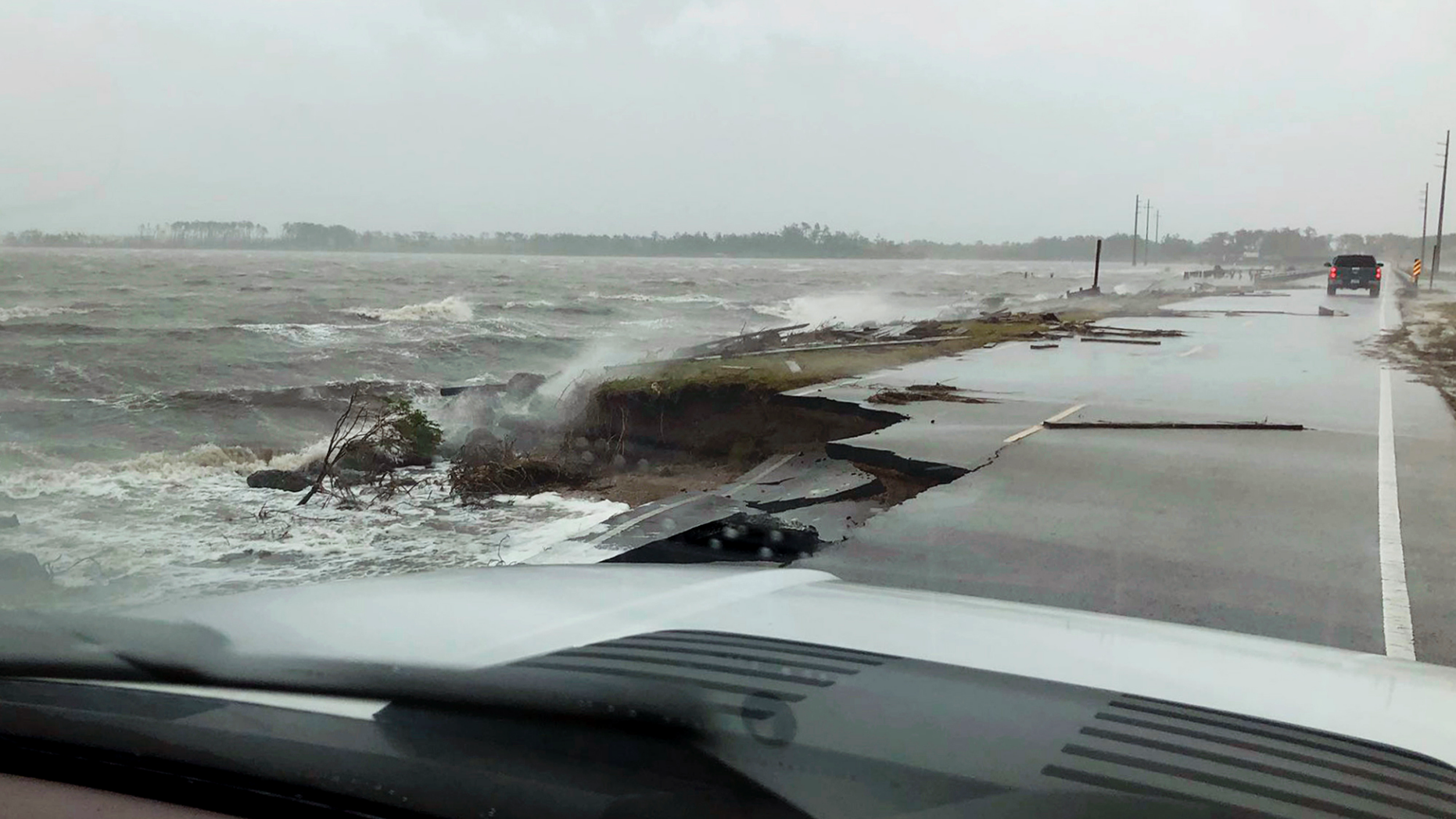 In this photo provided by Jordan Guthrie, wind and water from Hurricane Florence damages the highway leading off Harkers Island, N.C. on Friday, Sept. 14, 2018. (Jordan Guthrie via AP)