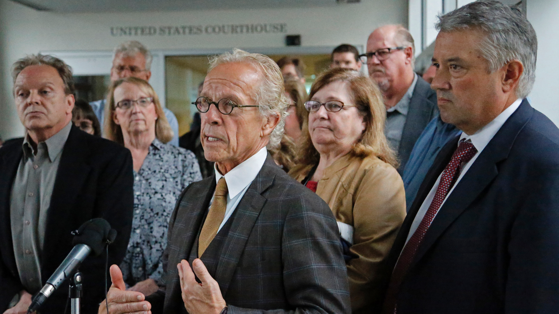 Attorney for clergy abuse survivors Jeff Anderson stands in front of survivors after a U.S. Bankruptcy Court approved a settlement that includes $210 million for victims of clergy sex abuse, Tuesday, Sept. 25, 2018, in Minneapolis. A U.S. Bankruptcy Court judge has approved a reorganization plan for the Archdiocese of St. Paul and Minneapolis that will compensate victims of clergy sex abuse. Hundreds of victims voted overwhelmingly in favor of the plan. (Shari L. Gross/Star Tribune via AP)